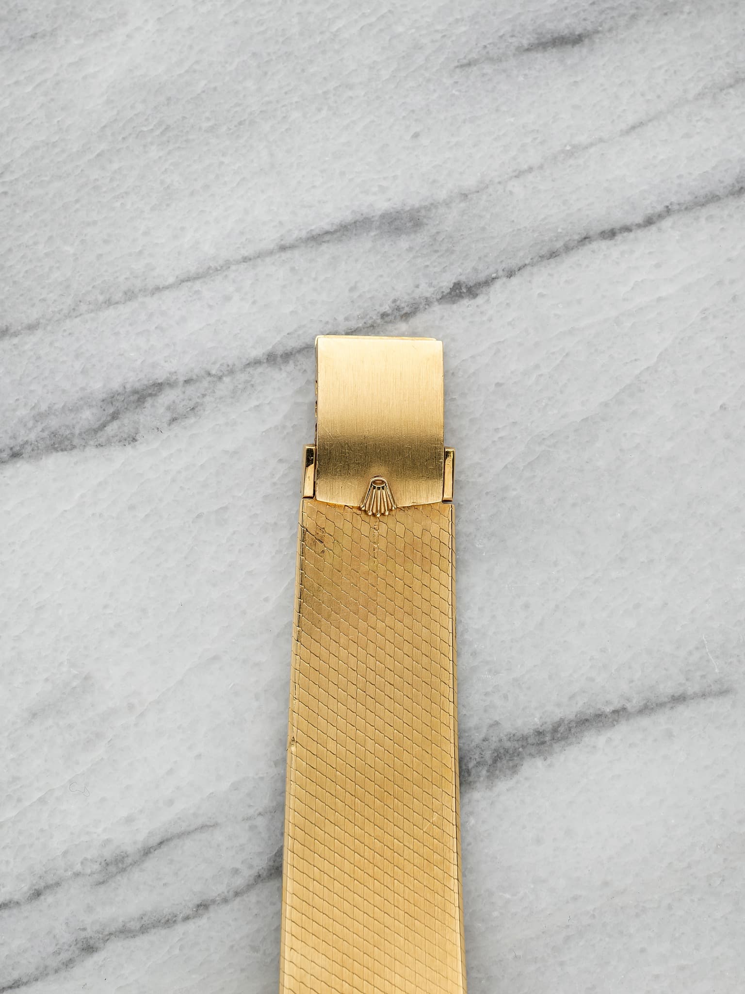 May be an image of brass, wrist watch and jewelry