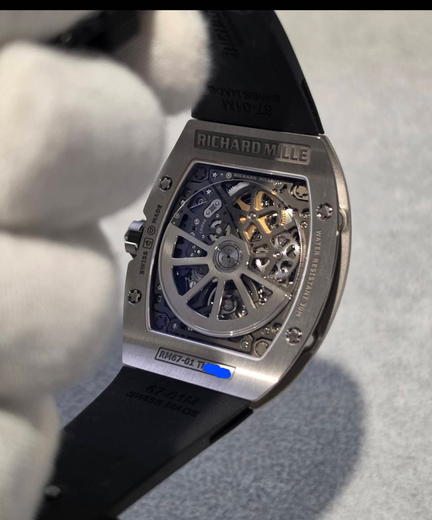 May be an image of wrist watch and text that says 'C ท WATER RESISTANT o 30M RM67-01TI RM67-01T7'
