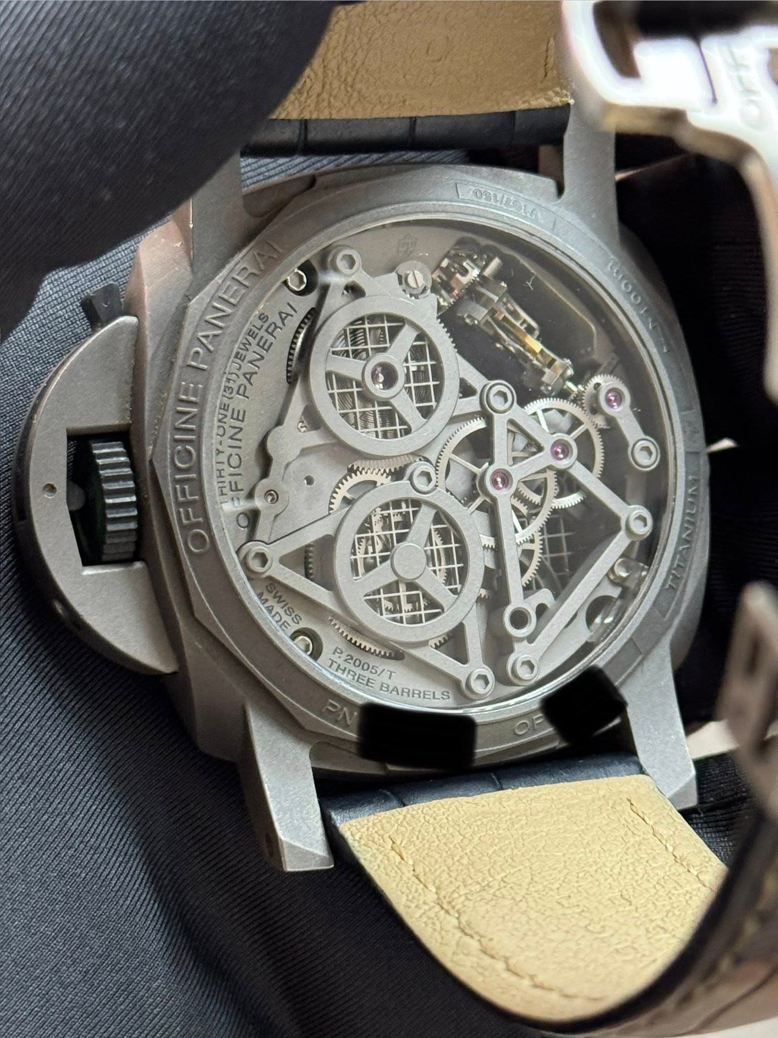May be an image of wrist watch and text that says 'TOSHIDTAG mOUA PANER PANERAI OFFICINE MUKTY-UNE FICINE ন IIII O NISS ADE ADE THREE P2005 THREE P.2005/ mYUUY p BARRELS O OE'