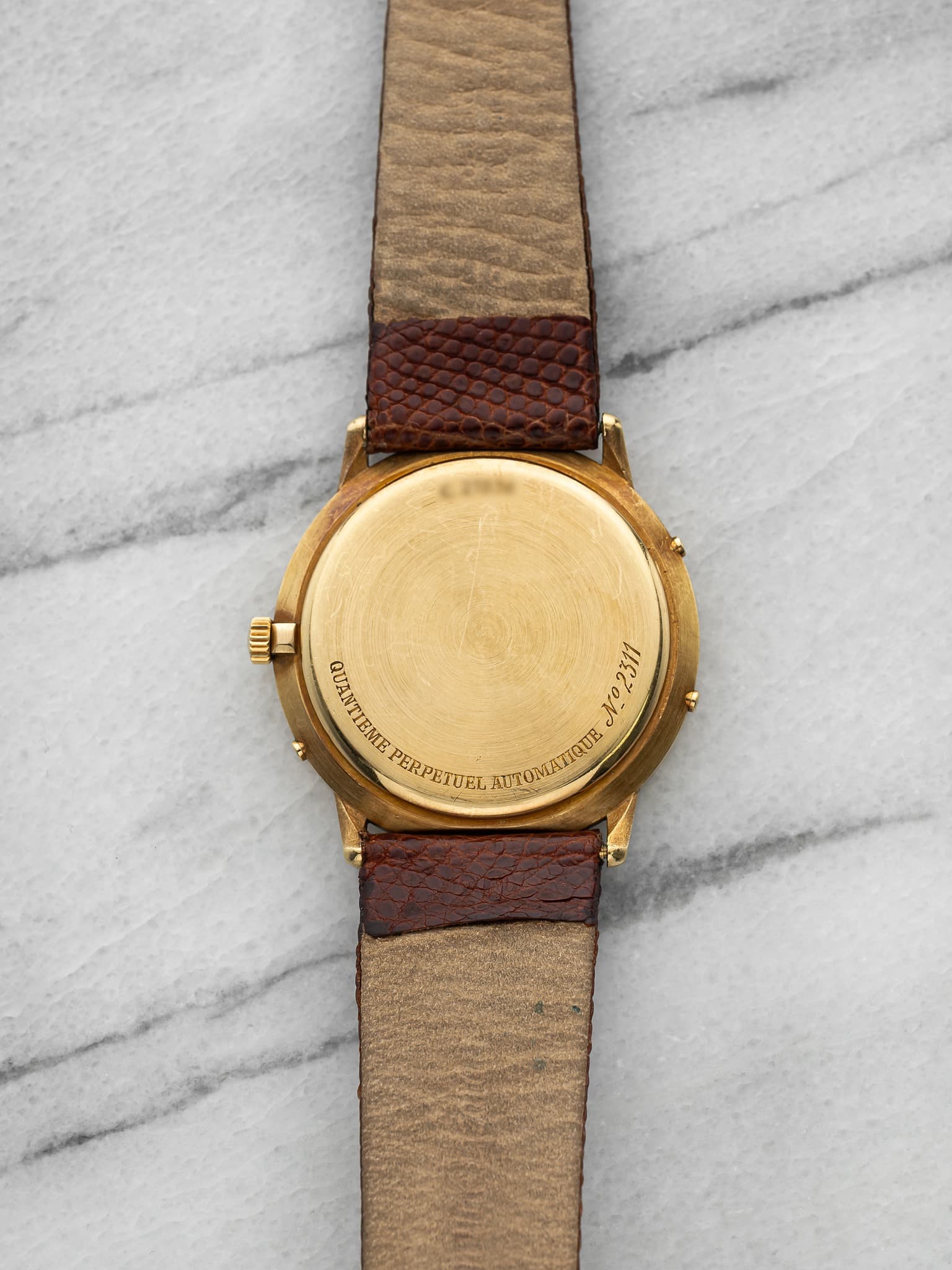 May be an image of leather, wrist watch and text