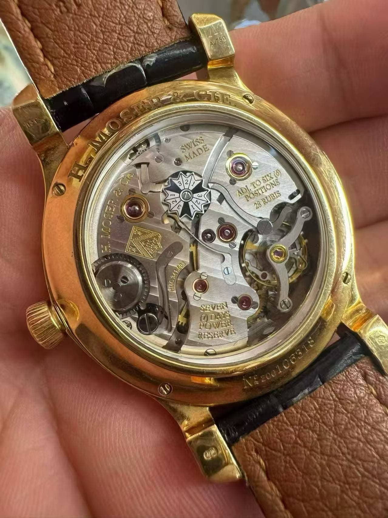 May be an image of wrist watch and text that says 'SWISS MADE ت 2 EVOSER i1 LLOGER ADI" ณ้ร POST POSLION 28 POSITIONS PO SIX(6) STTIONS ROUSS 103 SEVEN AY POWER RESERVE OrW'