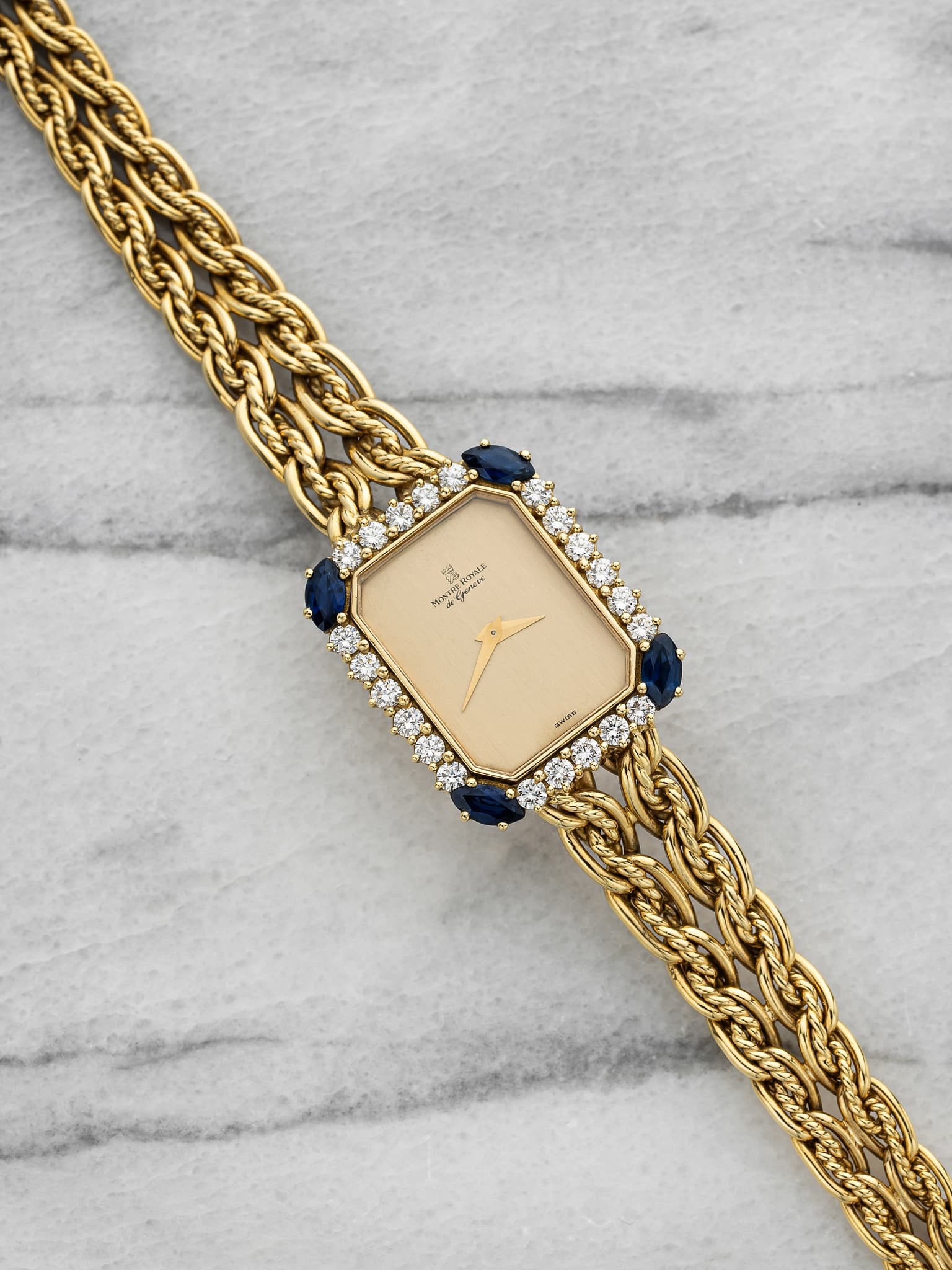 May be an image of jewelry, wrist watch and text