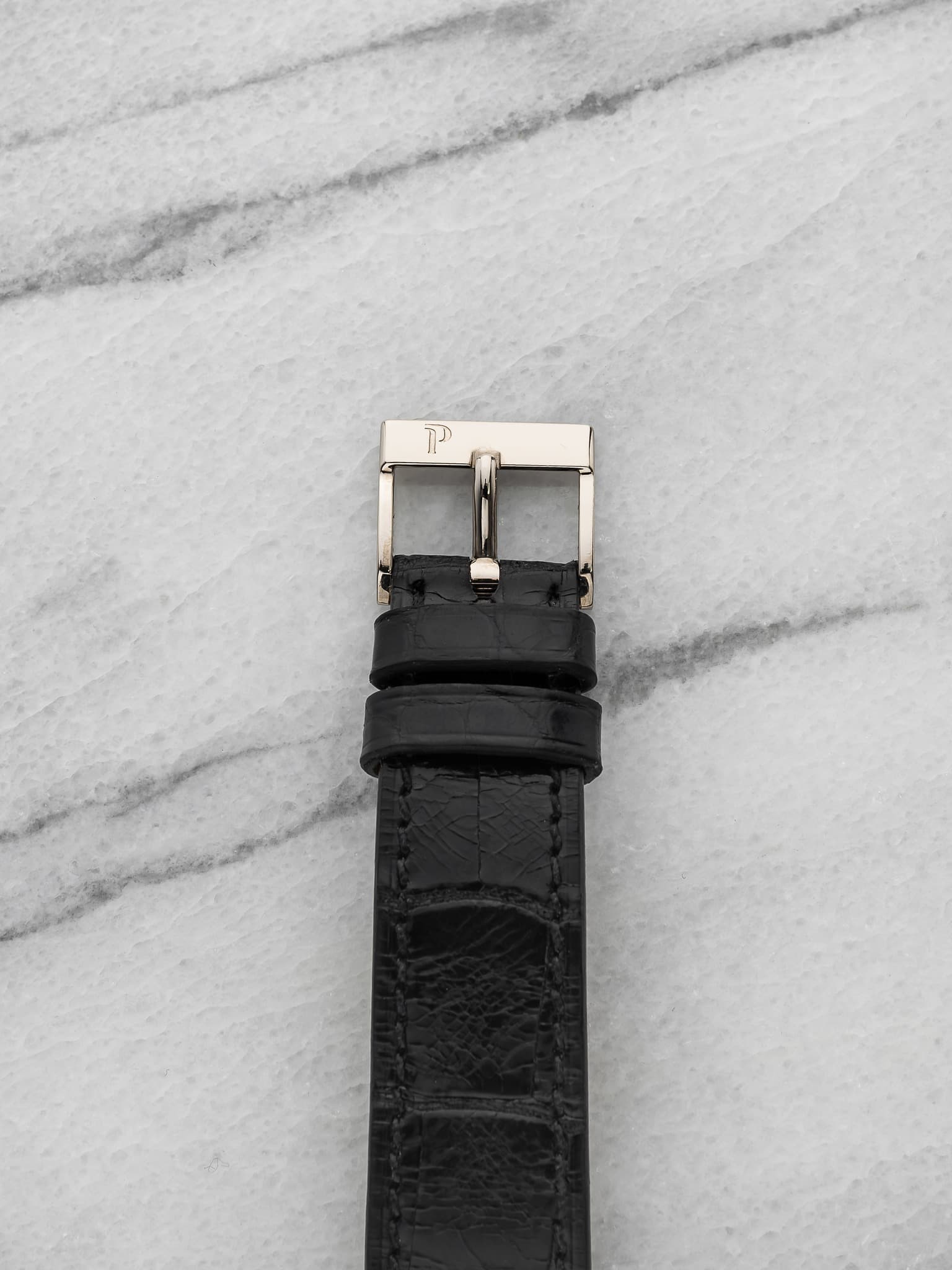 May be an image of saddle-stitched leather, wrist watch and leather