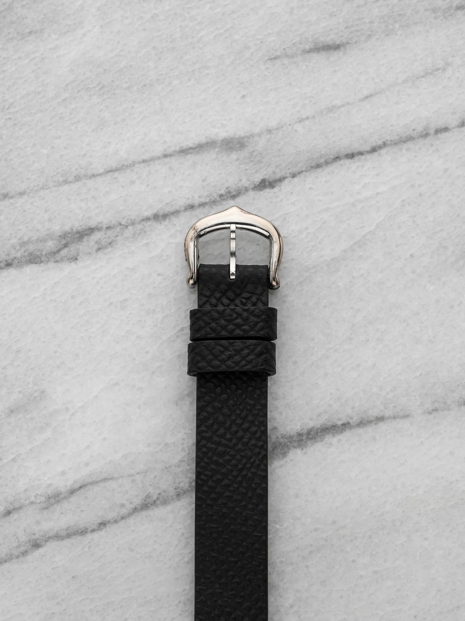 May be an image of saddle-stitched leather, wrist watch and leather