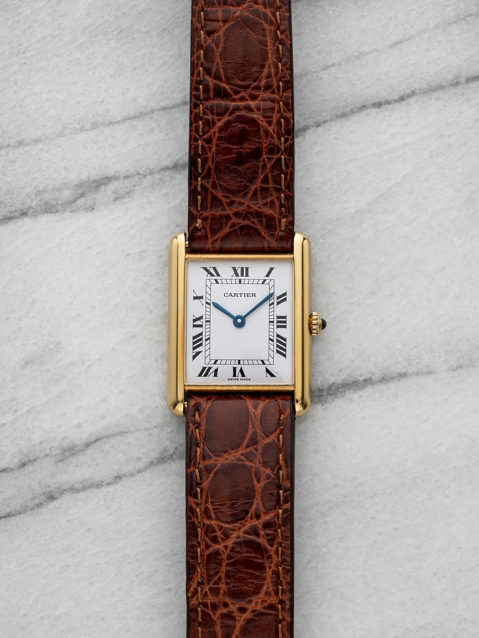 May be an image of wrist watch, leather and text