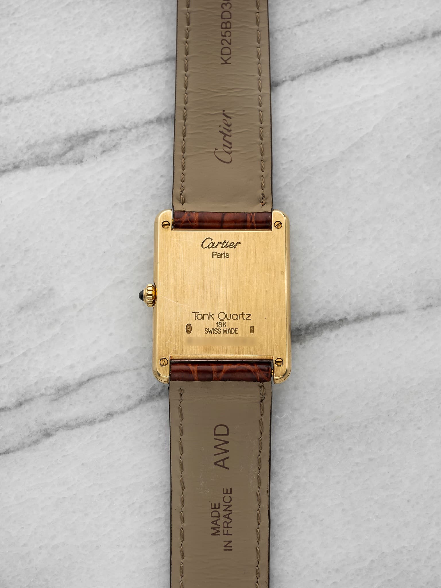 May be an image of leather, wrist watch and text that says 'Cartier Parts 信 لية TankQuartz Tank Quartz G SWISSMADE 1 SWISSMADE'