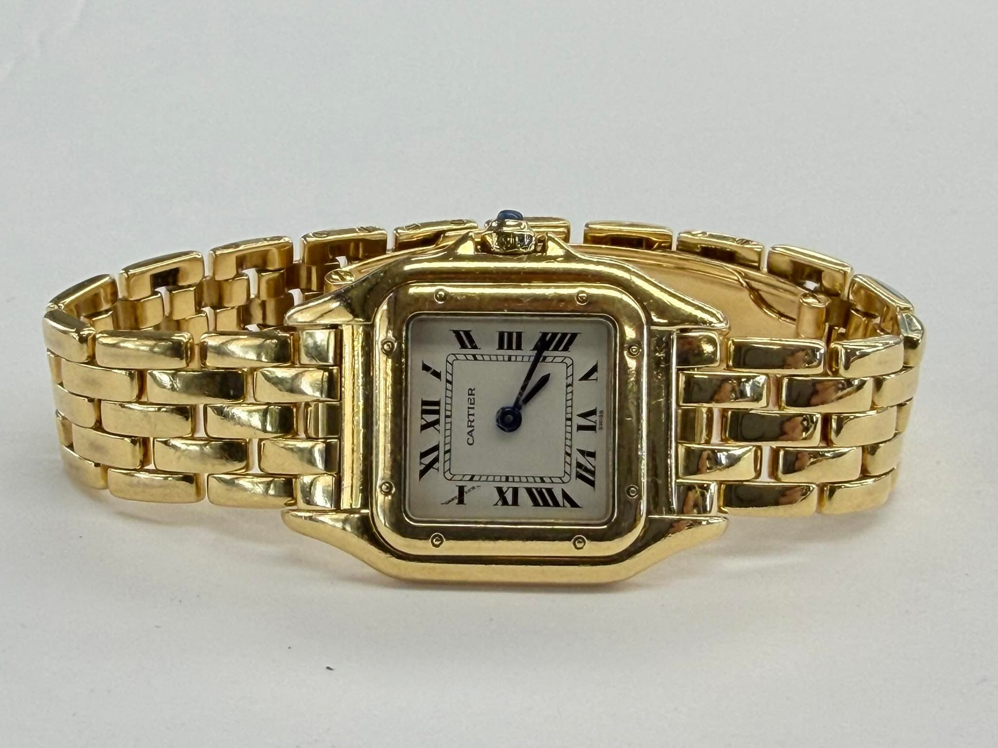 May be an image of wrist watch and text that says '@ IIIE Tm XII s CARTIER XI בבבל XIHIA (o) ©'