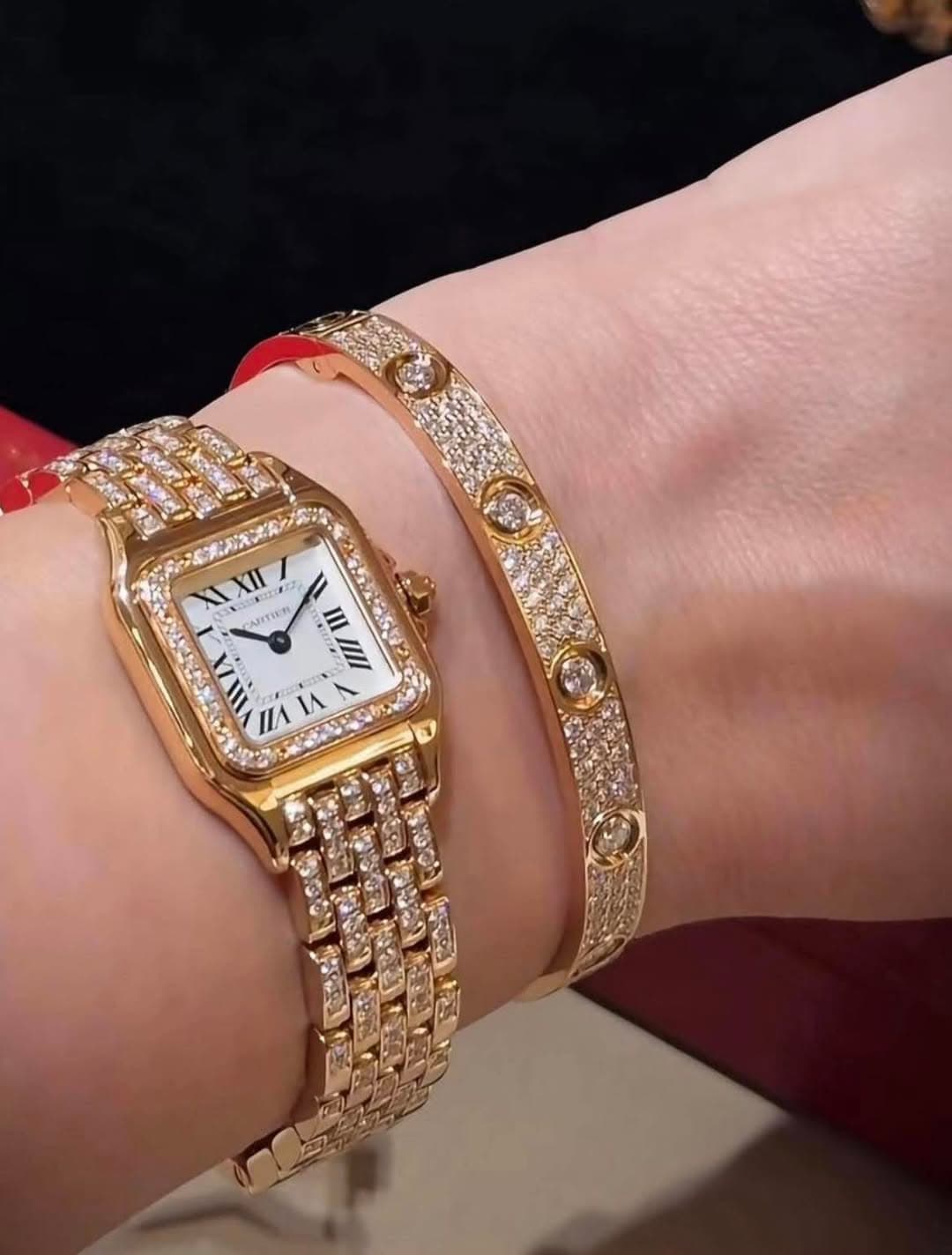 May be an image of jewelry, wrist watch and text