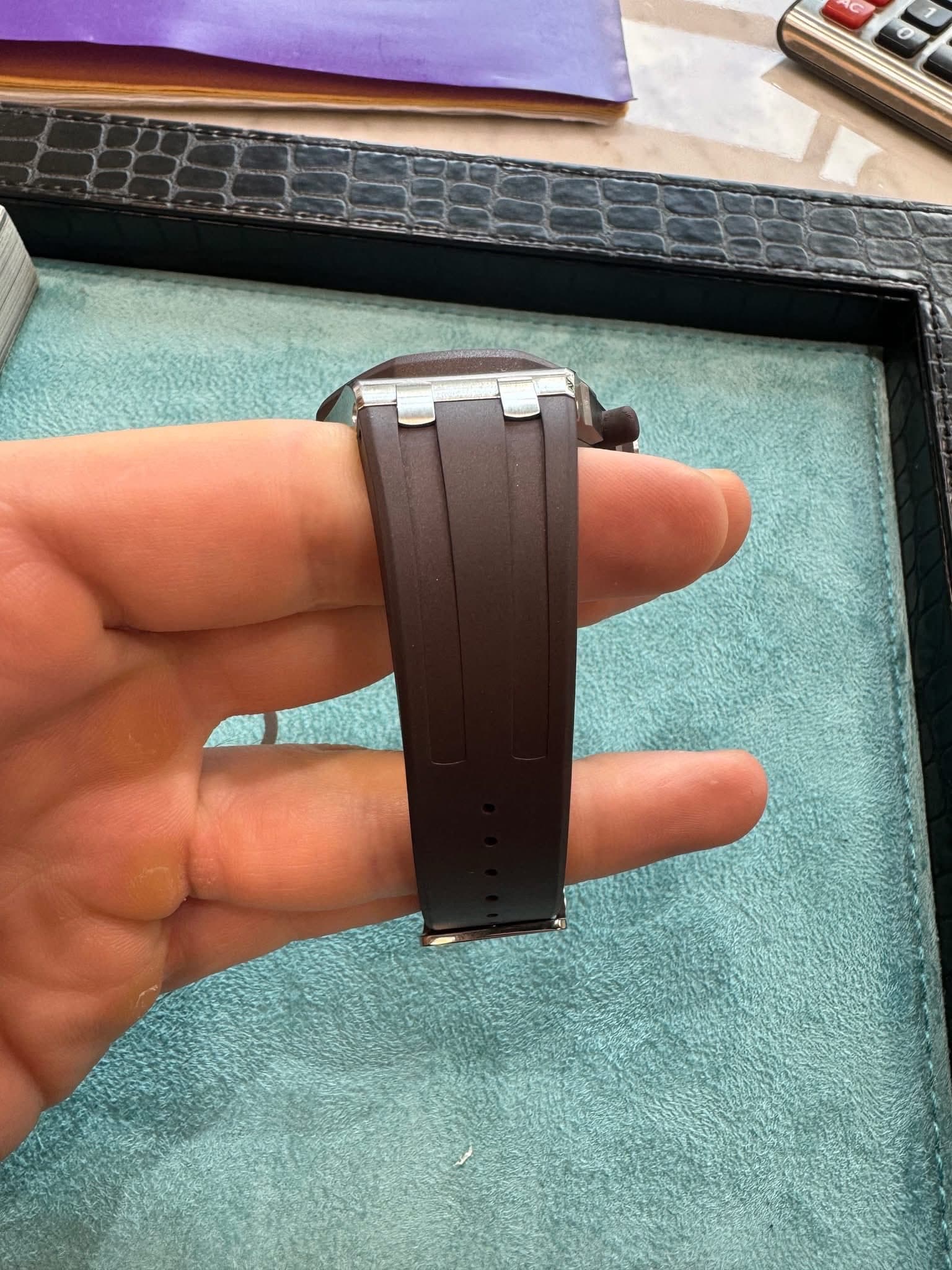 May be an image of wrist watch and saddle-stitched leather