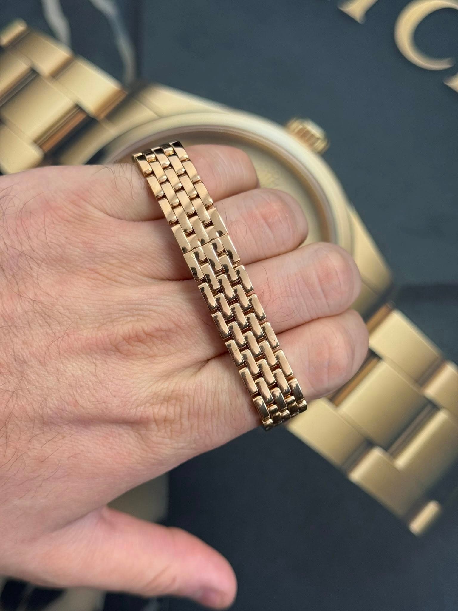 May be an image of jewelry, wrist watch and text