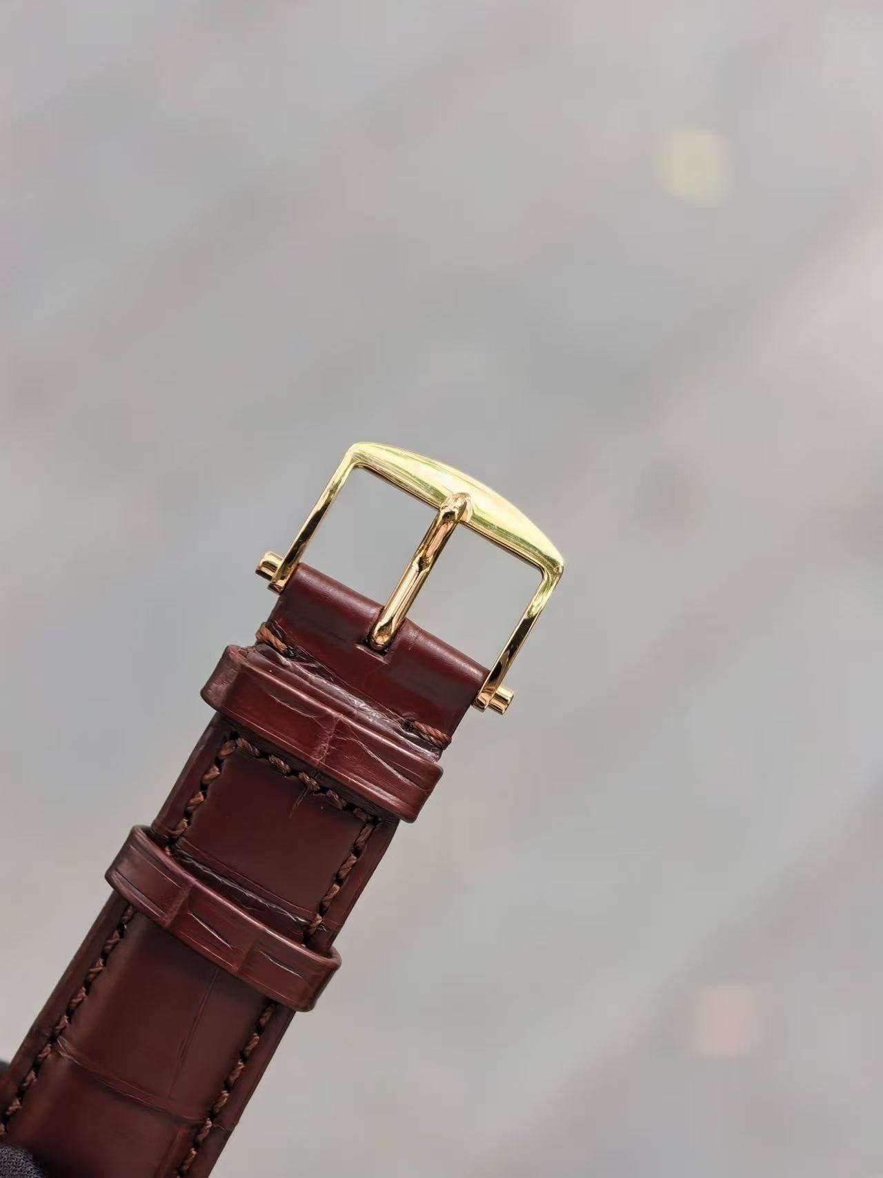 May be an image of wrist watch, saddle-stitched leather and leather