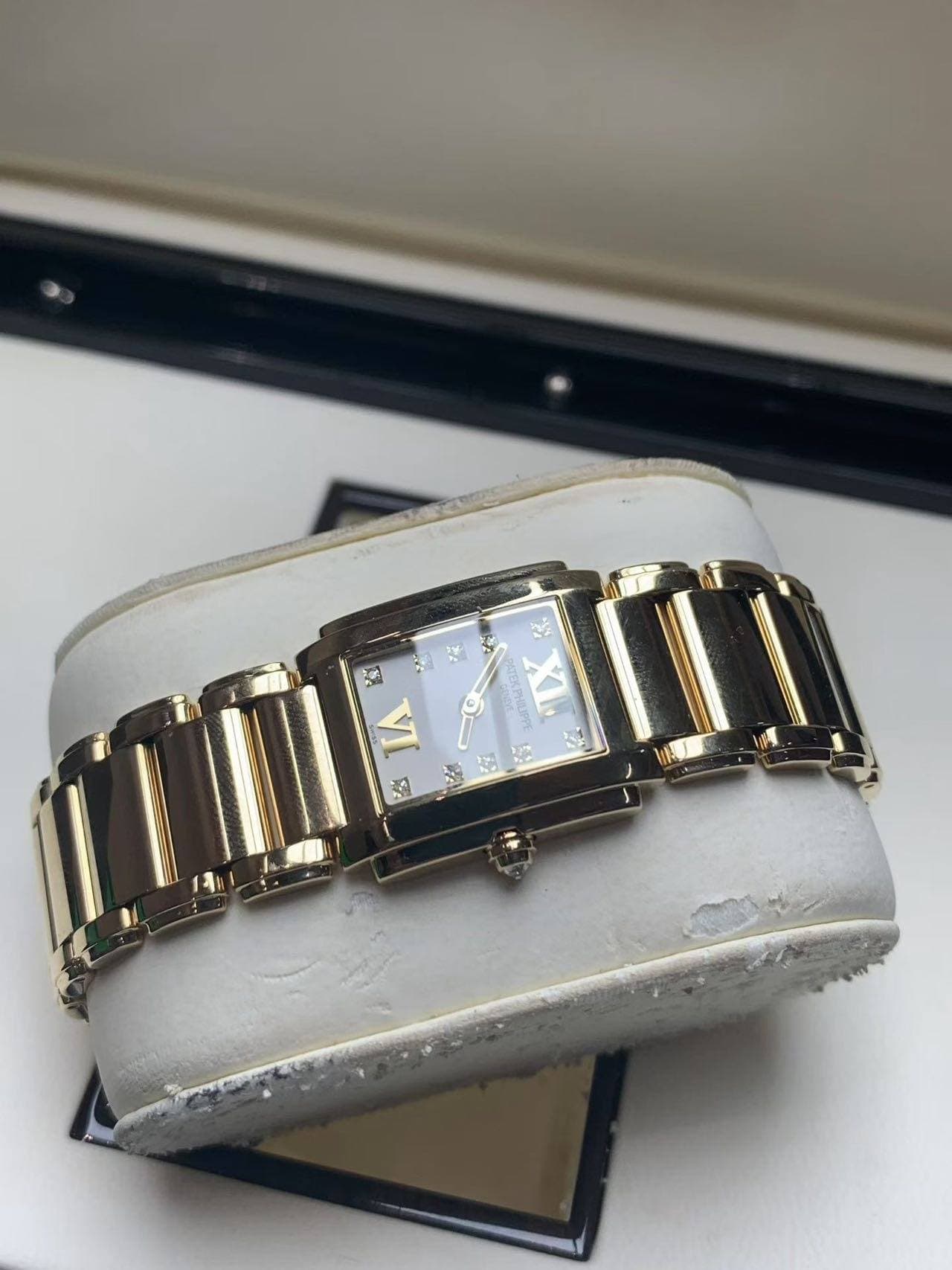 May be an image of jewelry, wrist watch and text