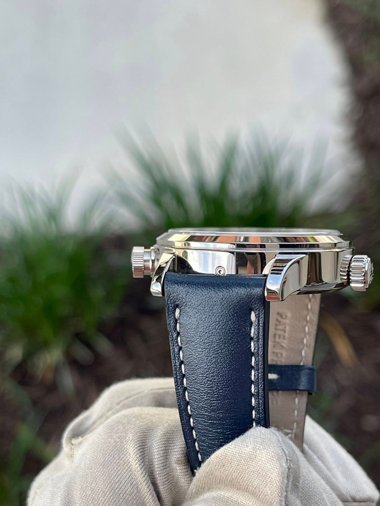 May be an image of saddle-stitched leather, wrist watch and text