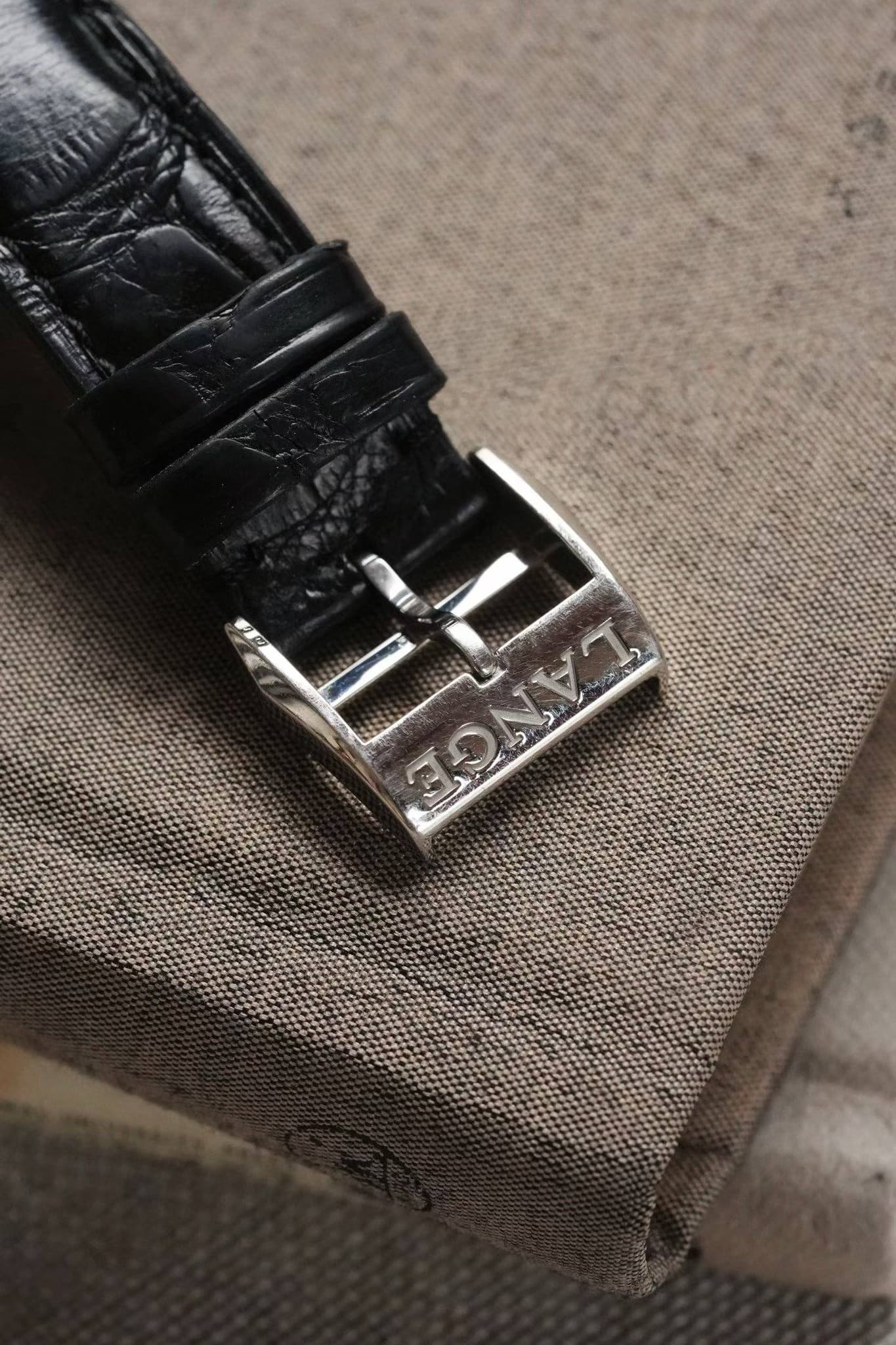 May be an image of saddle-stitched leather, leather and wrist watch