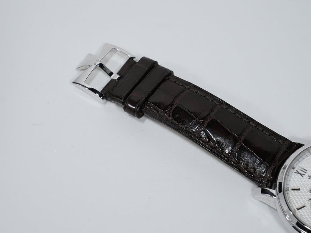 May be an image of wrist watch, leather and text that says 'Xii'