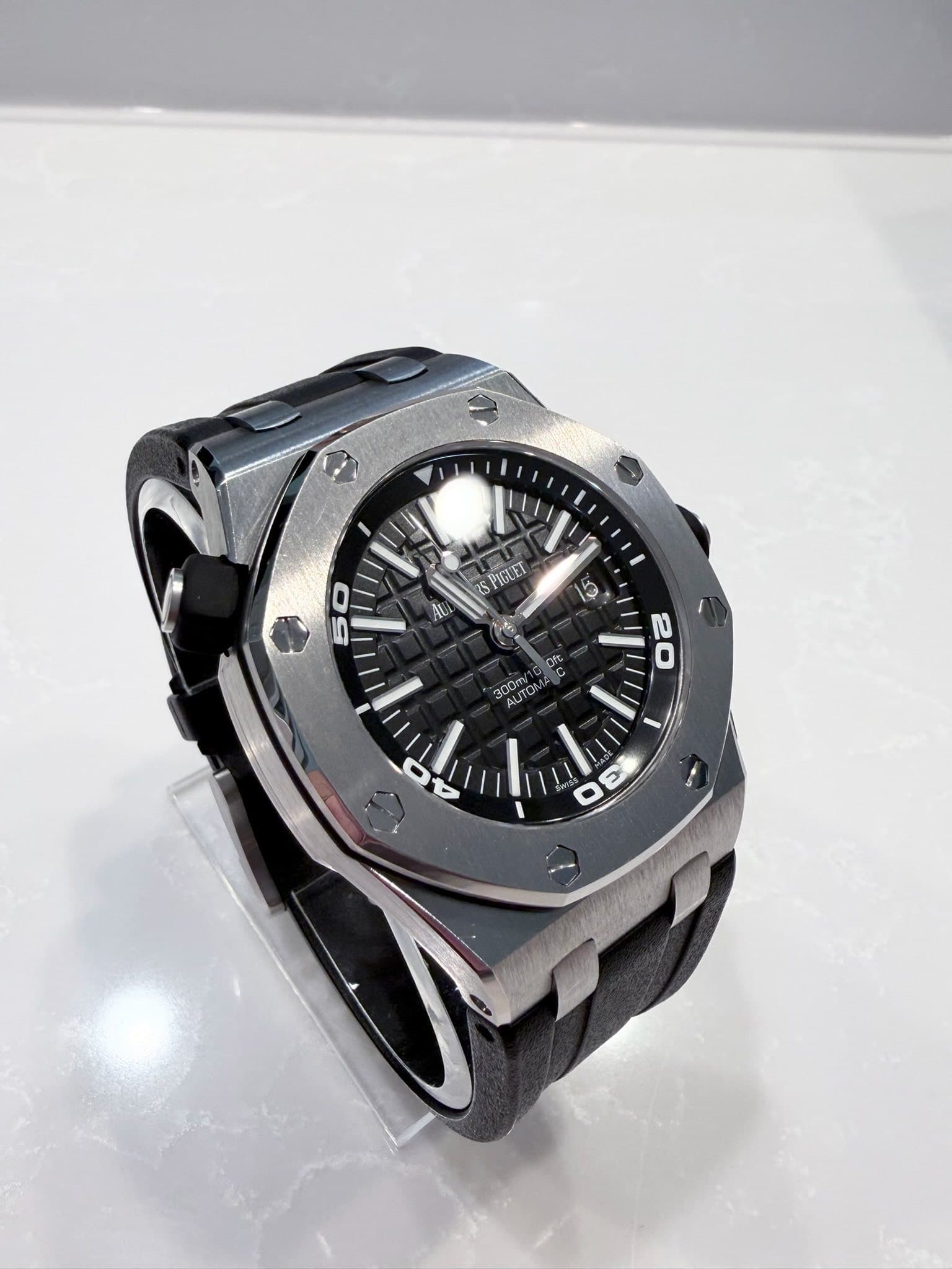 May be an image of wrist watch and text that says 'יו 25 PIGLET n AU 50 Ofc ofC M 300m/1 AUTO AUTON UTS NOA COm 20 3 بد'