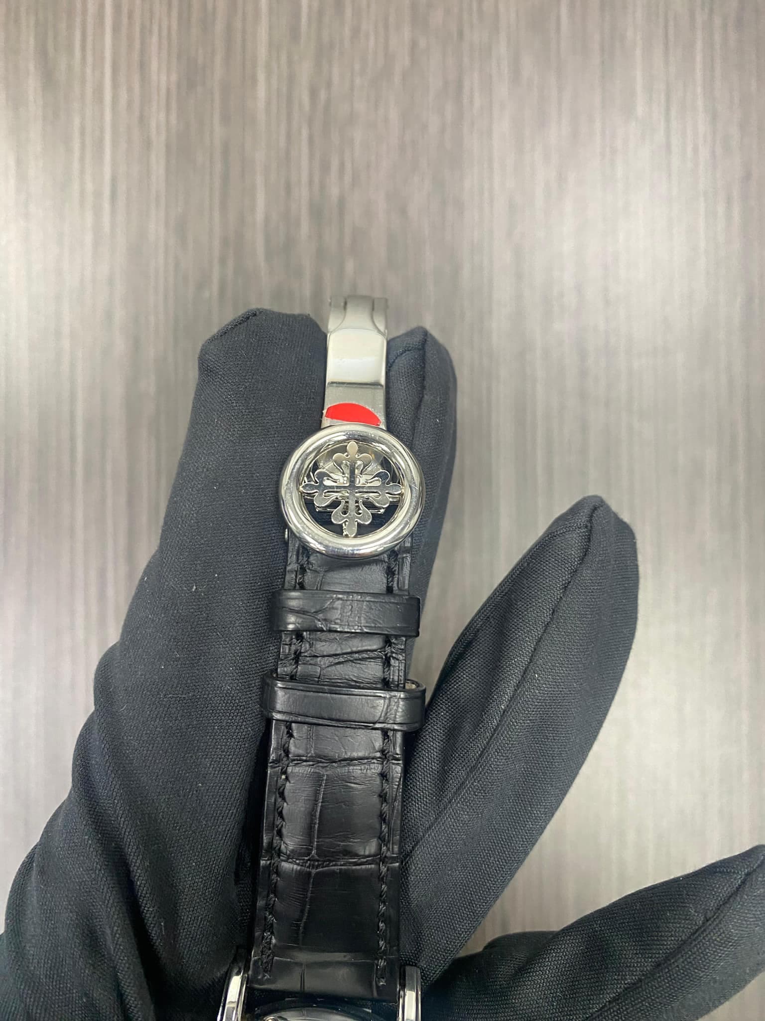 May be an image of wrist watch, leather and text