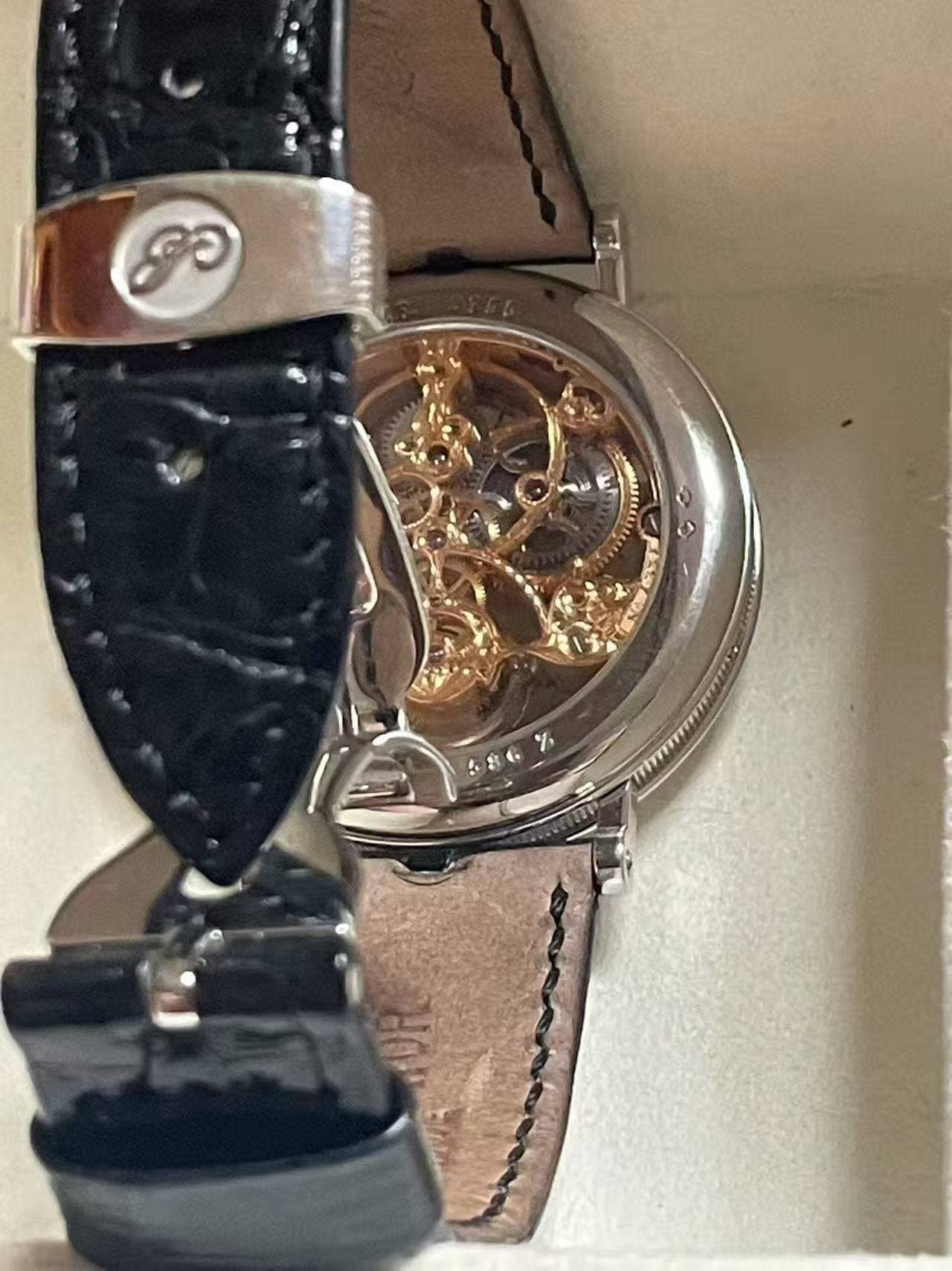 May be an image of wrist watch and text