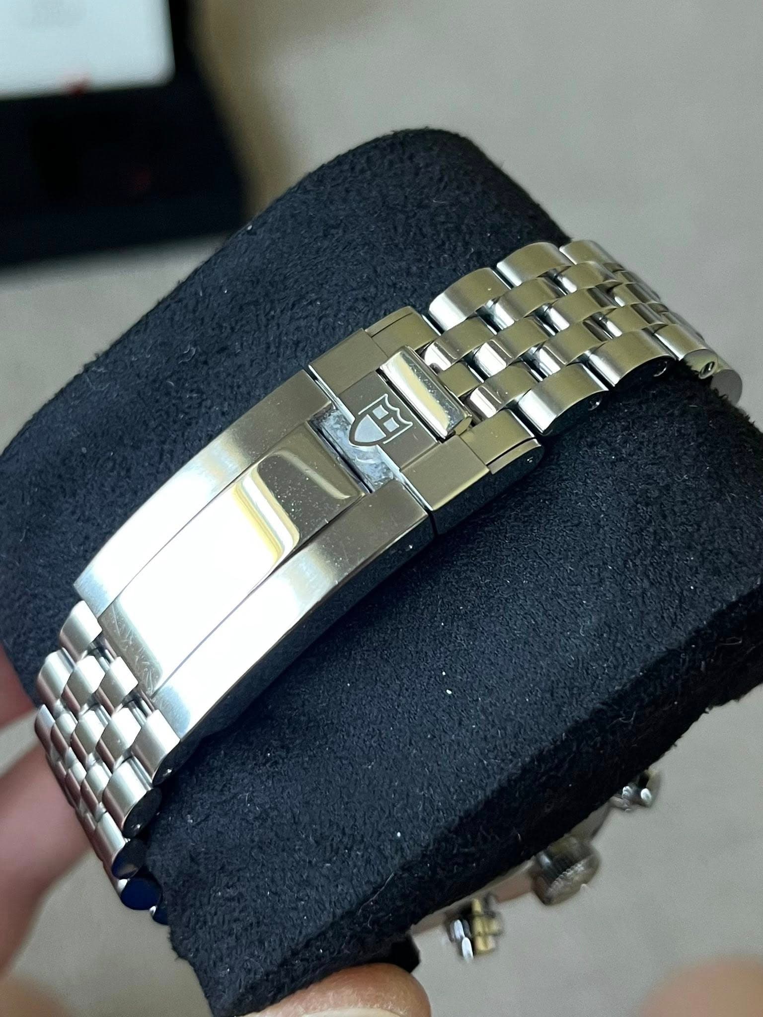 May be an image of jewelry, wrist watch and text
