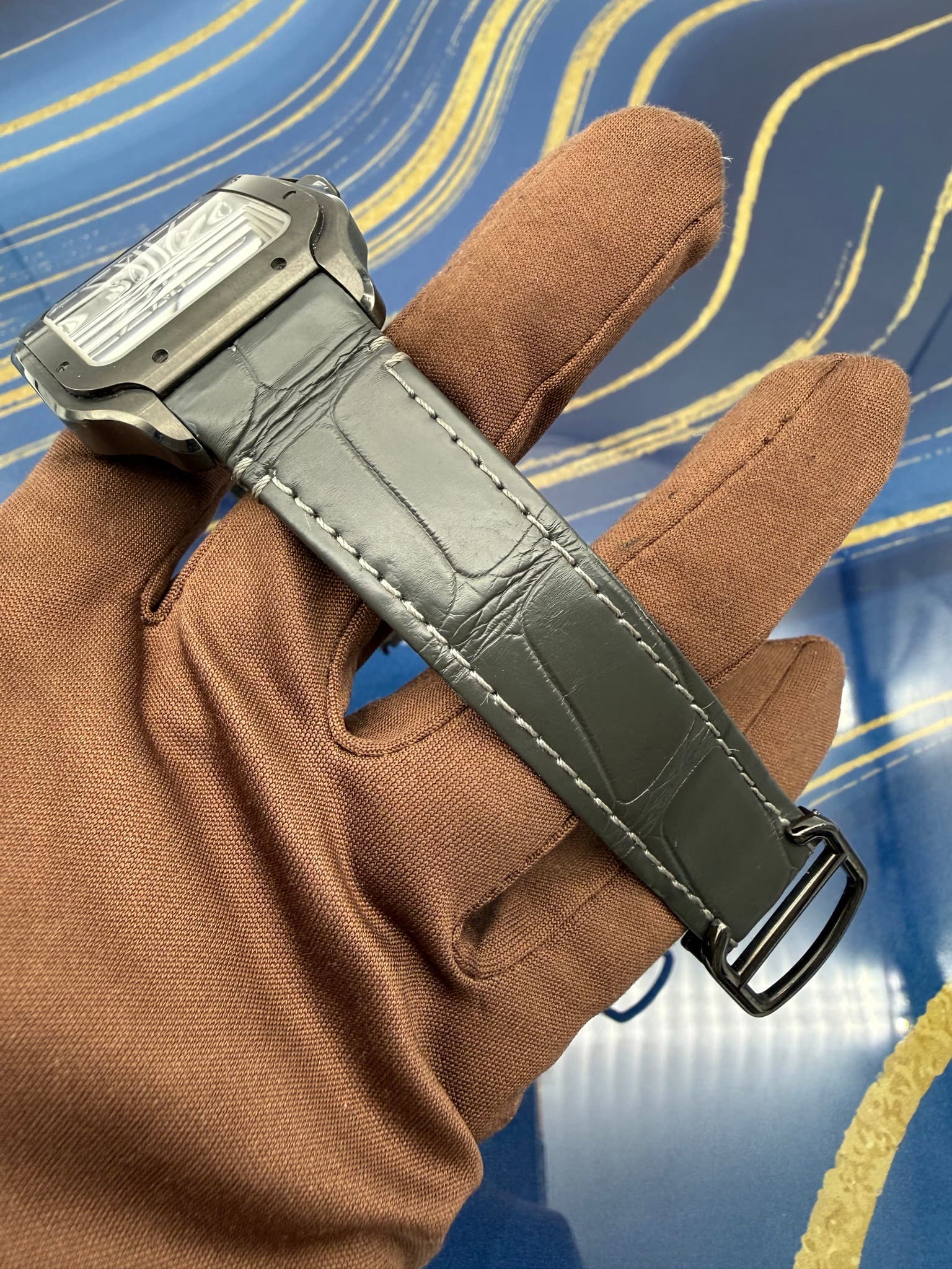 May be an image of wrist watch, leather, saddle-stitched leather and text