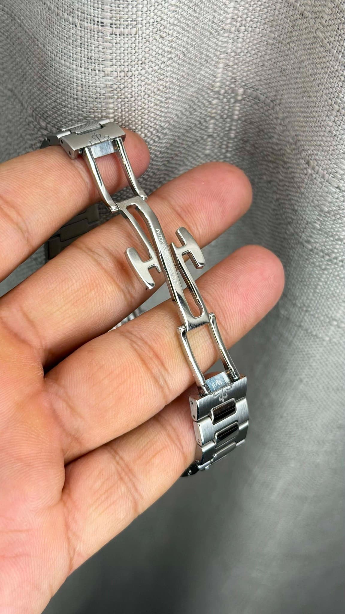 May be an image of wrist watch, jewelry and text