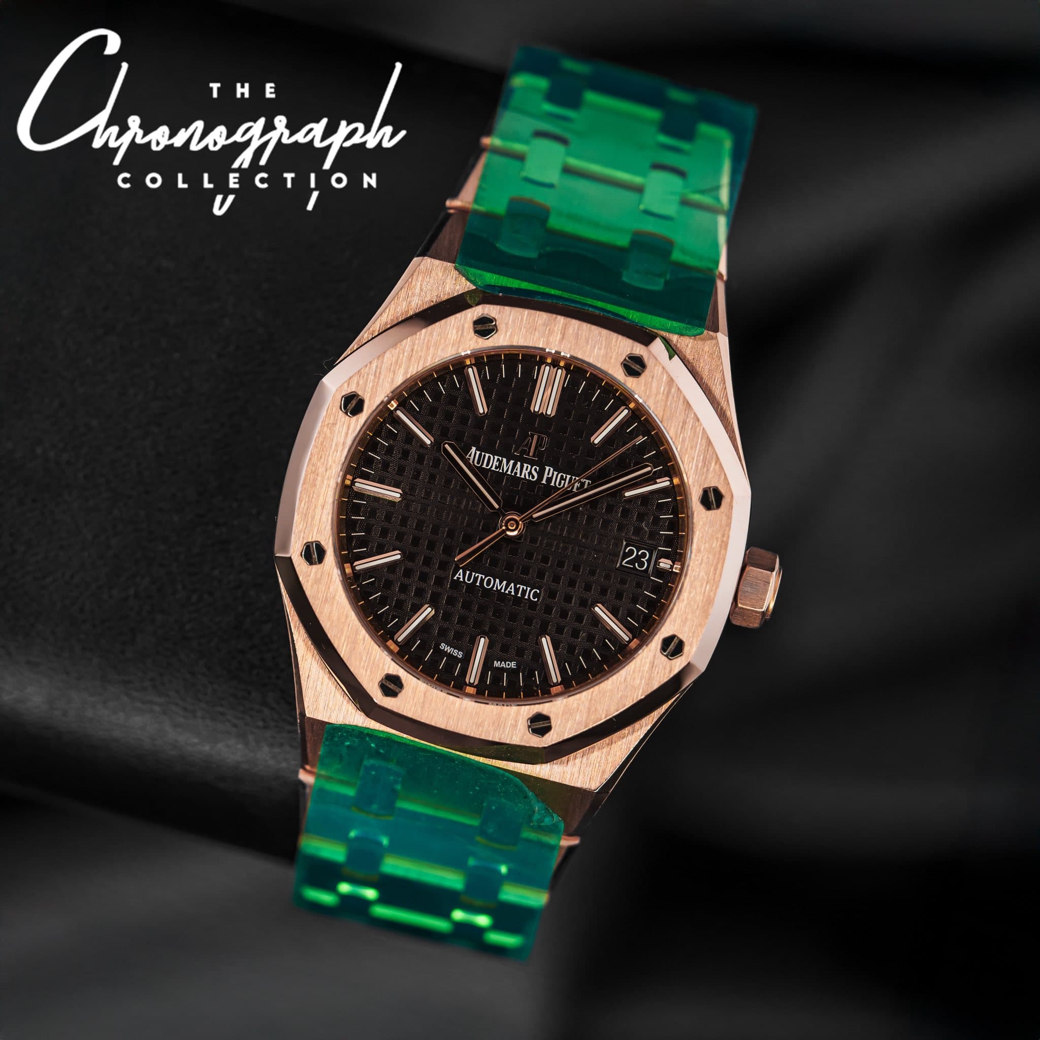 May be an image of wrist watch and text that says 'Agaainjaph ponograph THE COLLECTION TION 5 UDEMARS AUDEMARSPIGIET PIGI ΟΜΑ MATIC 23 S'