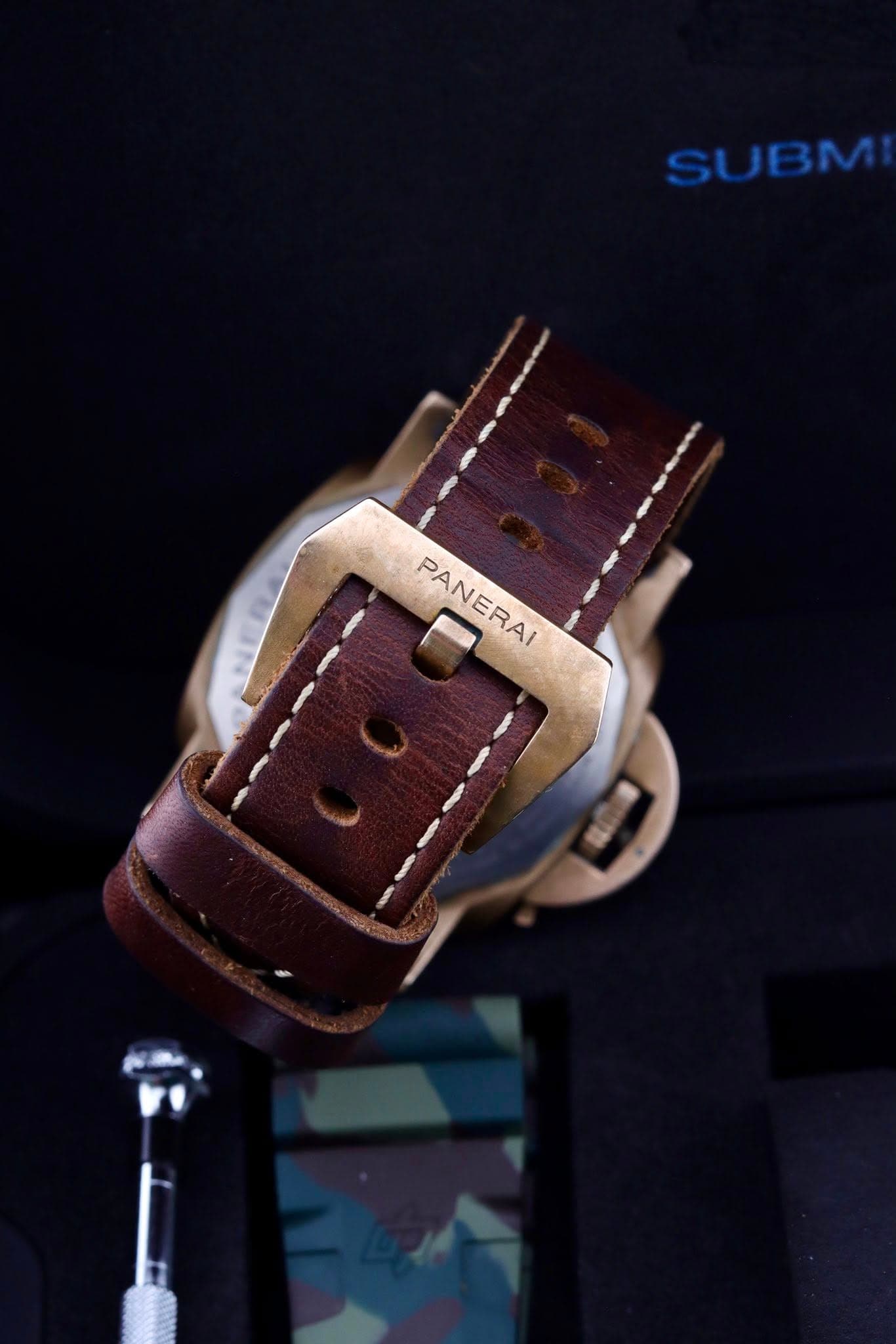 May be an image of saddle-stitched leather, wrist watch and text that says 'SL SUBM PANERAI PANERA'