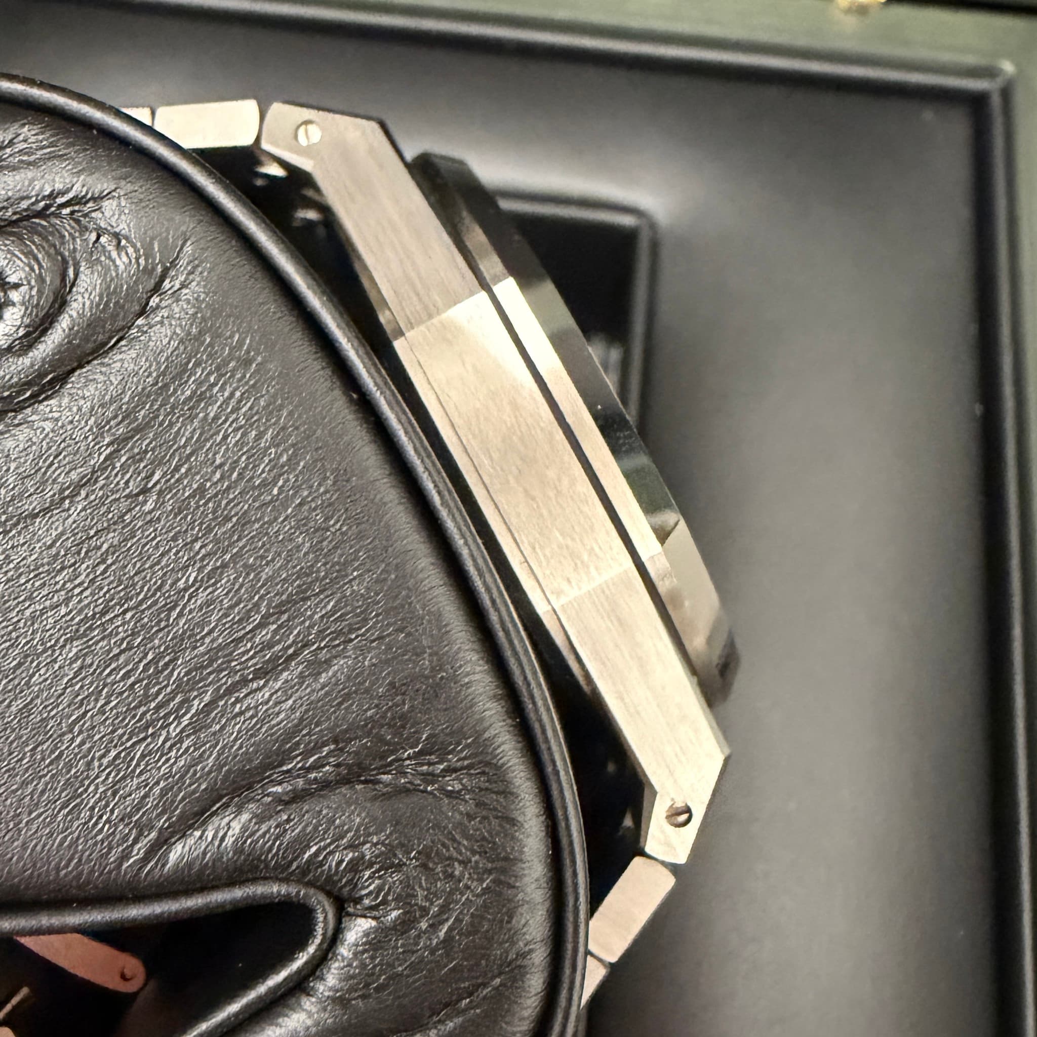 May be an image of leather wallet, wrist watch, leather and saddle-stitched leather