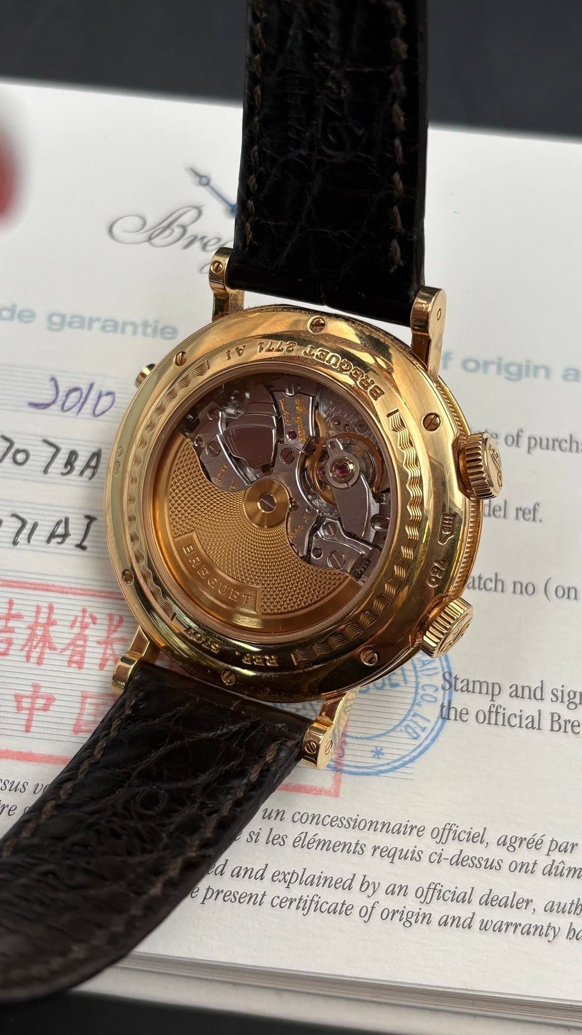 May be an image of wrist watch and text that says 'ABre de garantie ह 22E 有認合中冬園歩せ目 L3OS ်ပျင်အေညန origin טוסנ 7o 7BA HAI of purch itel ref. atch no (on 林雪子 中 รนร U re Stamp and…