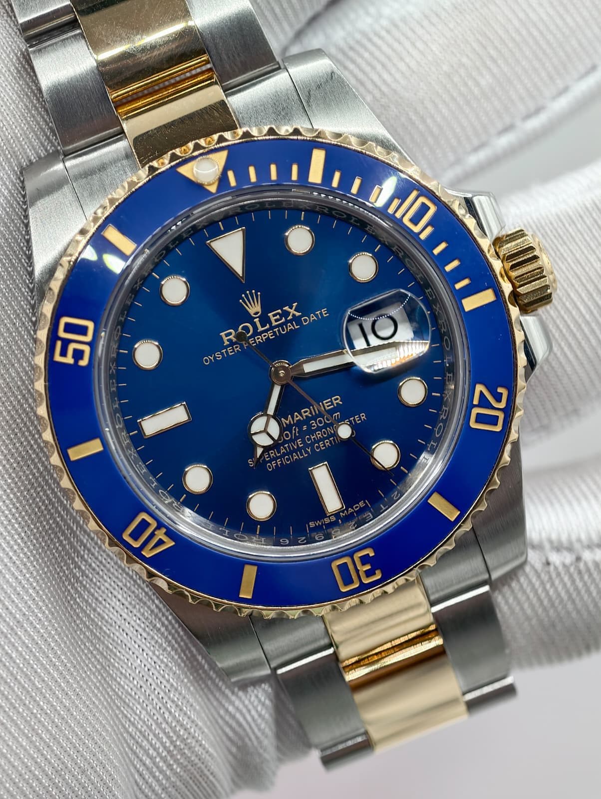 May be an image of wrist watch and text that says ' ROLEX R ERPETUALDATE ERPET DATE OYSTER MARINER ER 07e3OC MARI Oft= '