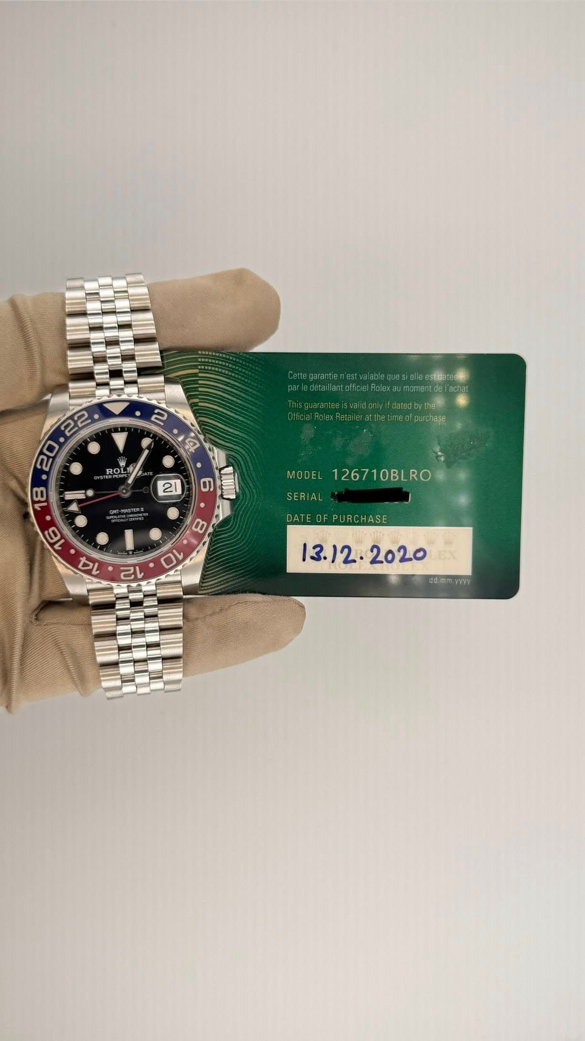 May be an image of wrist watch and text that says '2 4 ROL ROL 22 20 18 II EUI MODEL 126710BLRO SERIAL .'
