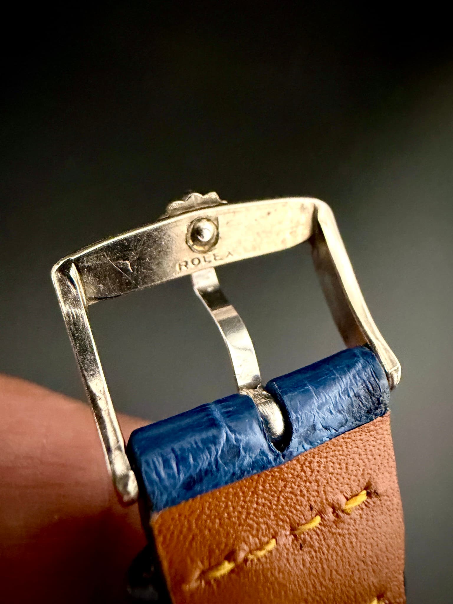 May be an image of wrist watch and saddle-stitched leather
