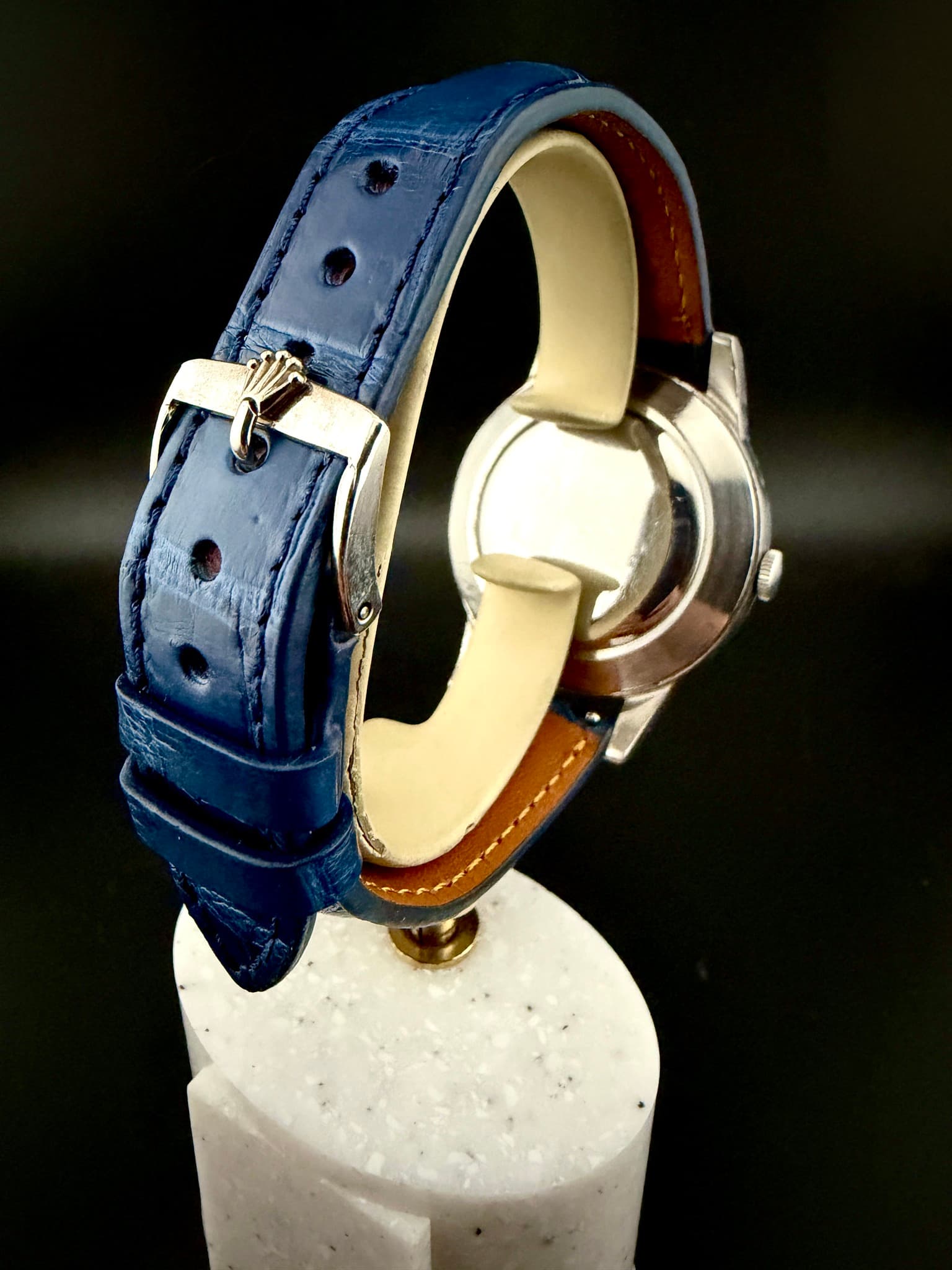 May be an image of saddle-stitched leather, wrist watch, leather and text