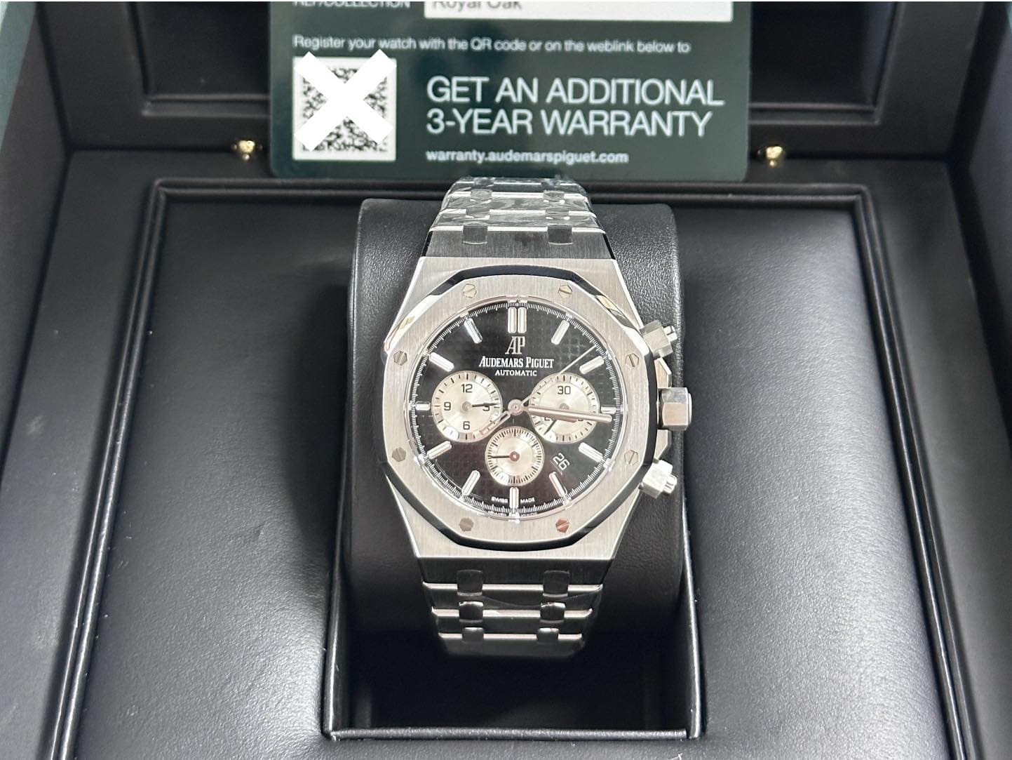 May be an image of wrist watch and text that says 'O ်သြို် Register your watch with OR code the weblink below to めででん GET AN ADDITIONAL 3-YEAR WARRANTY warantyaudemarspiguet.com S…