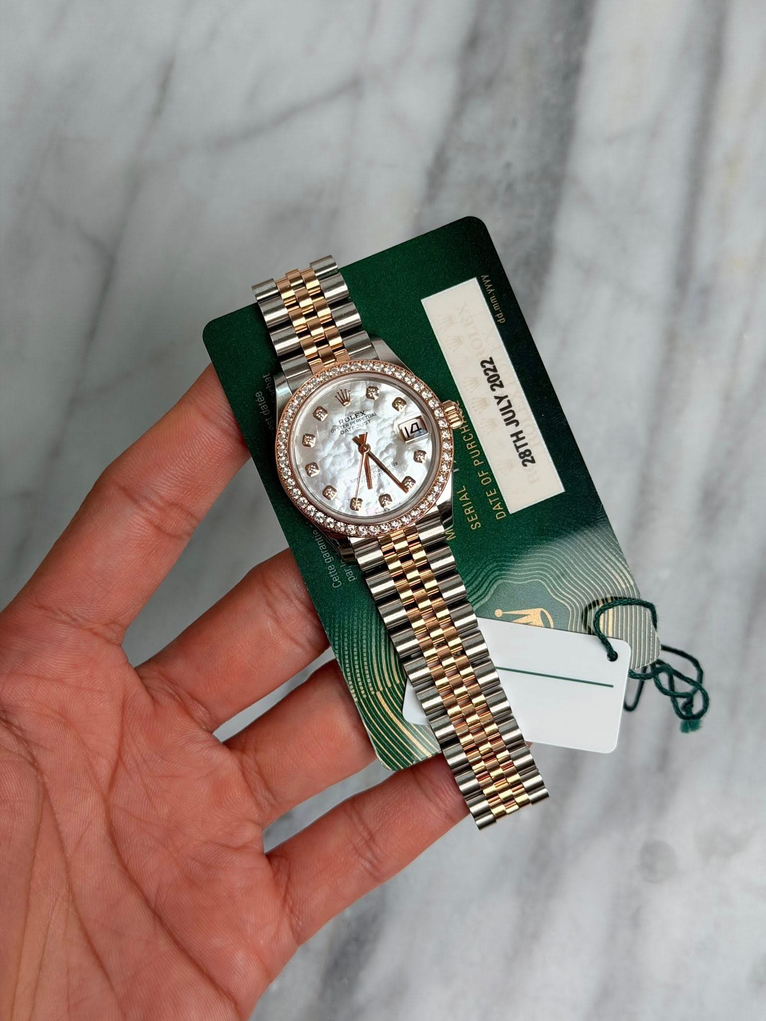 May be an image of wrist watch and text