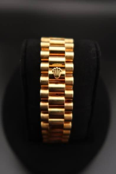 May be an image of jewelry, wrist watch and text