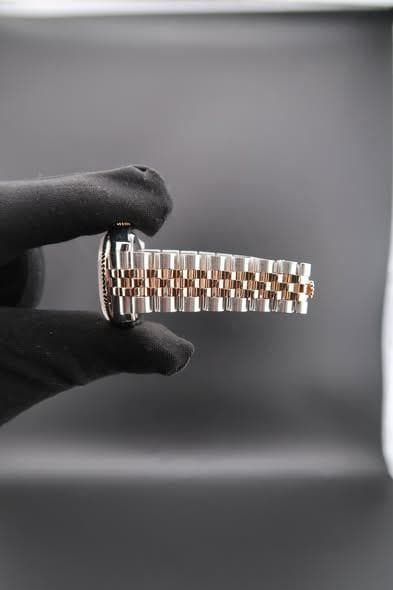 May be an image of wrist watch and jewelry