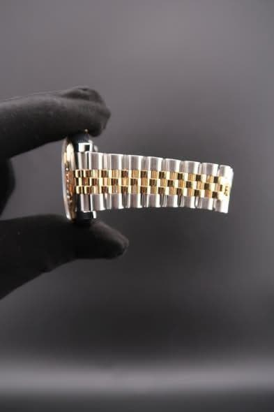 May be an image of wrist watch and jewelry