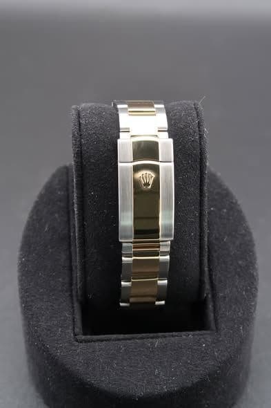 May be an image of wrist watch, jewelry and text