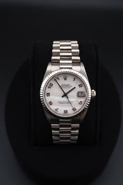 May be an image of wrist watch and text