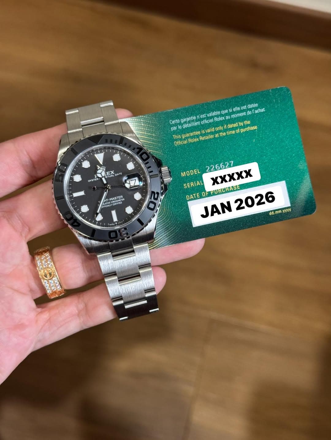 May be an image of wrist watch and text that says 'Q治 eлec moment stdatee Yachat CeT4e garantie parle détaillant officiel n'estvalable Ralexa guarantse valid Otficial oiex Retailer…
