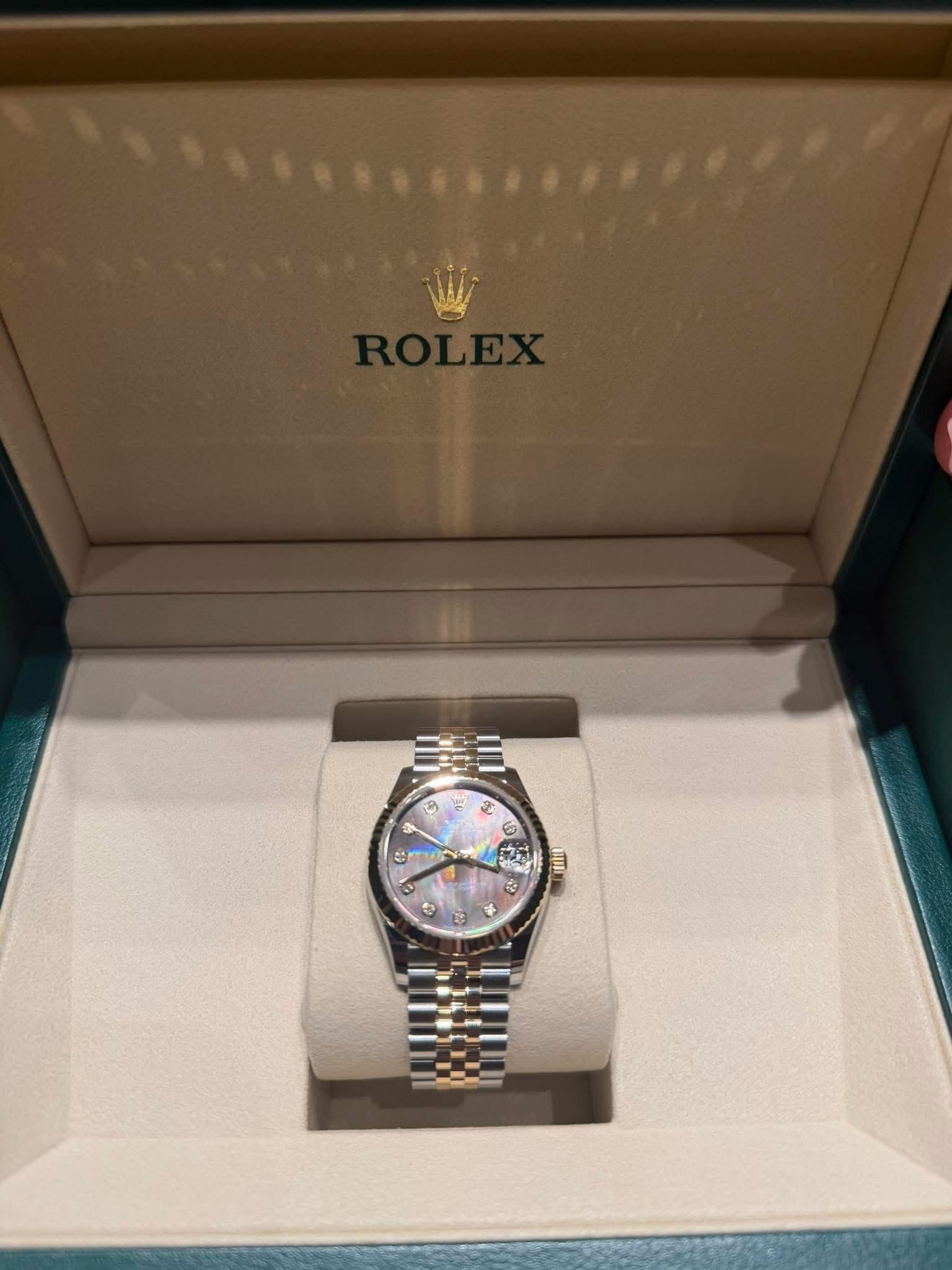May be an image of wrist watch and text