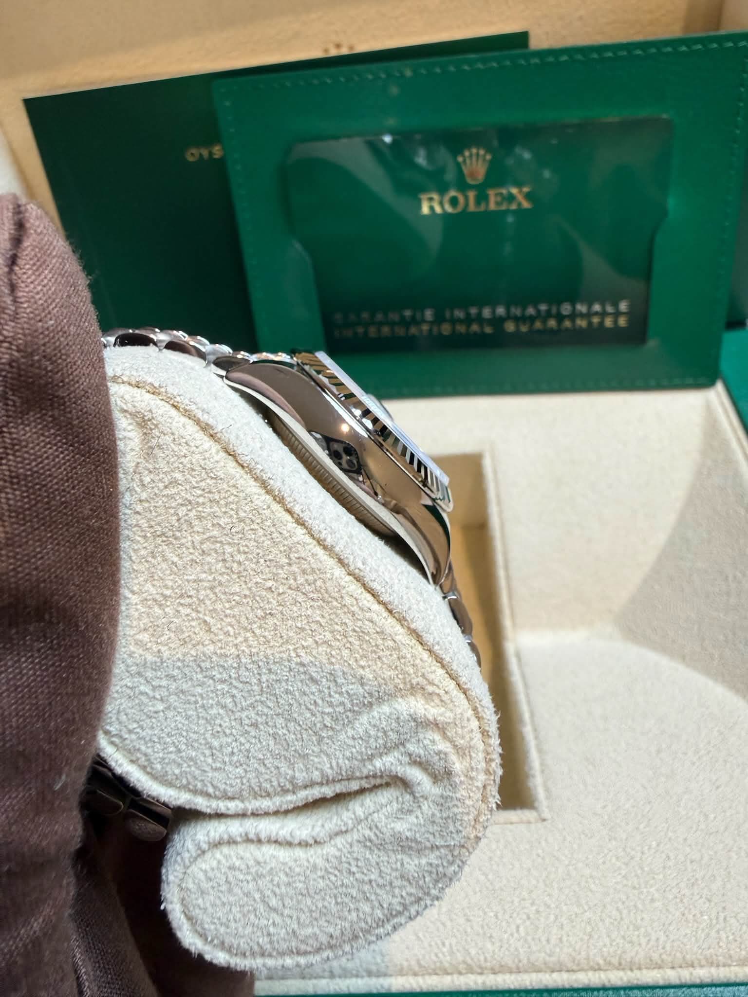 May be an image of wrist watch and text that says 'ROLEX'