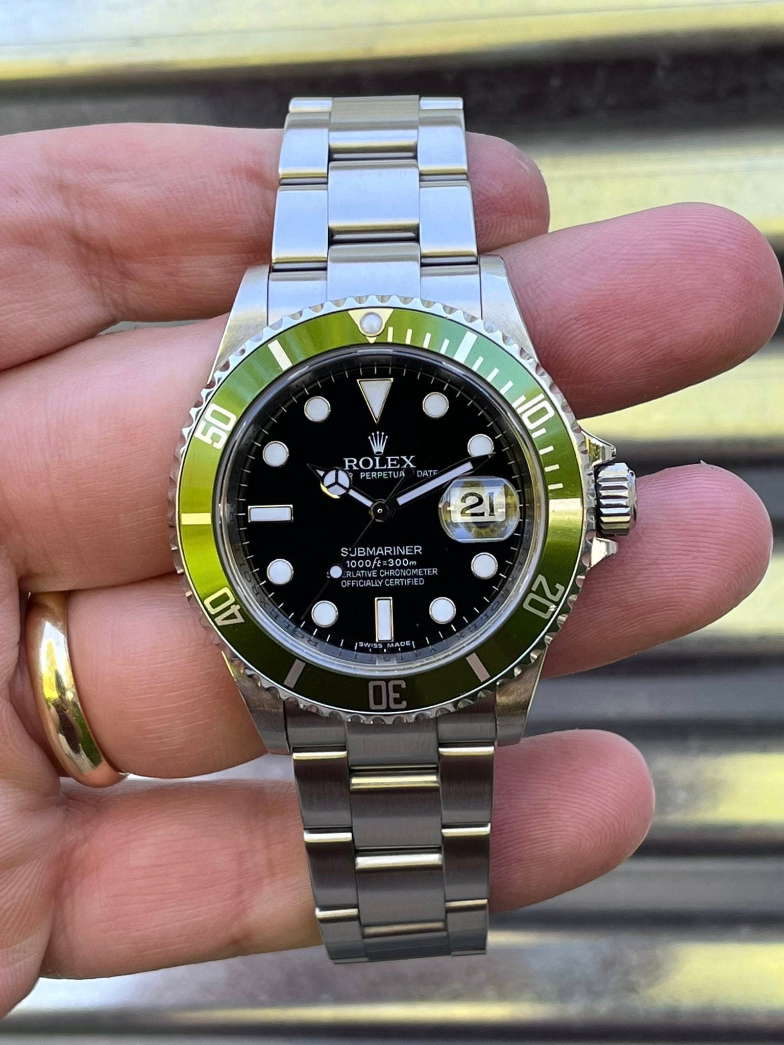 May be an image of wrist watch and text that says '50 50 ROLEX 10 21 SJ JBMARINER SJBMARINER ER oft:300m 40 20'