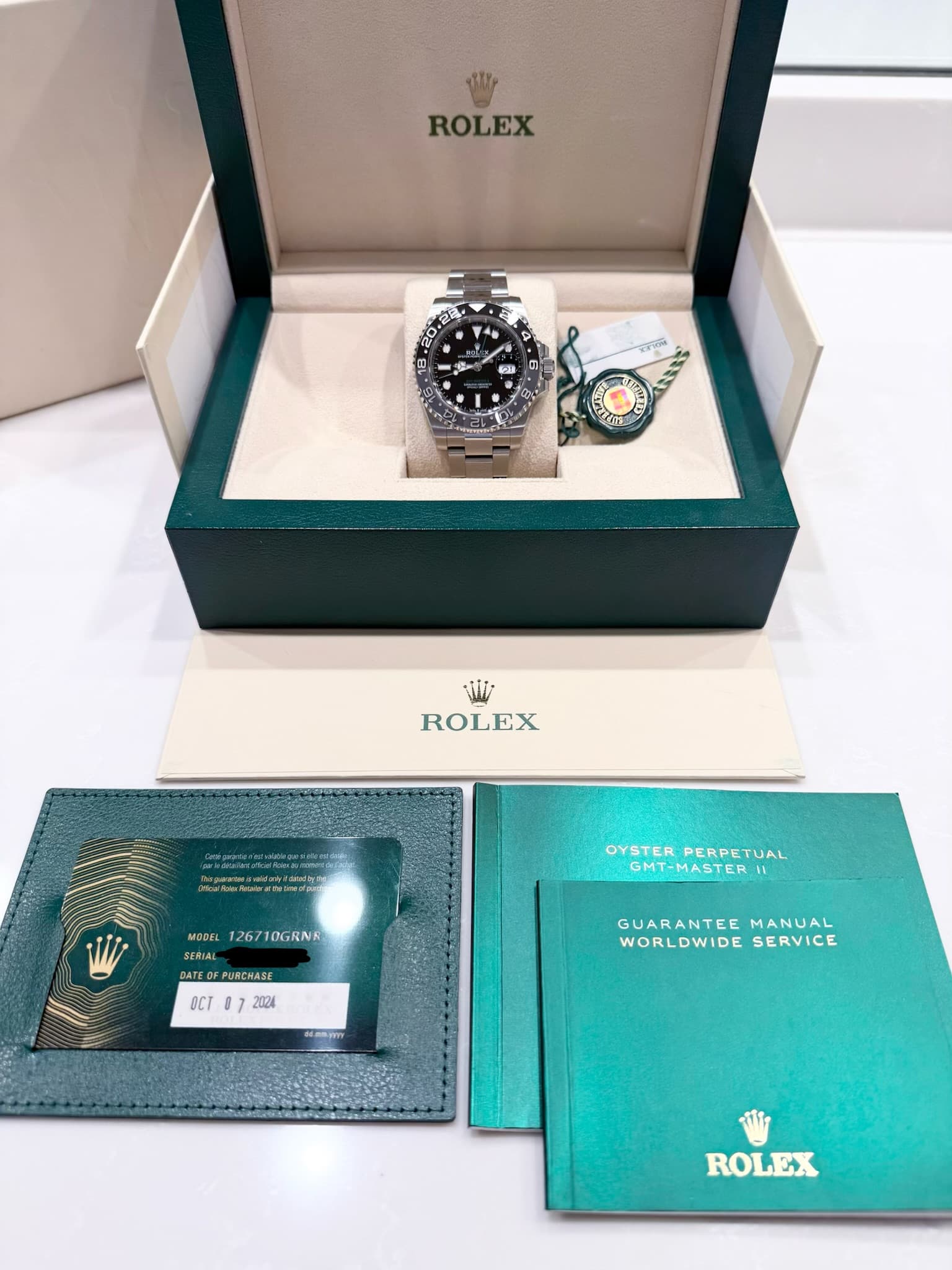 May be an image of wrist watch and text that says 'W ROLEX 20 ぎ 4 ㆍ 5 لت 0 L Si ROLEX NwARuk.cRHLw.dp OYSTER OYSTERPERPETUAL PERPETUAL MT-MASTERI MODEL 126710GRNR…
