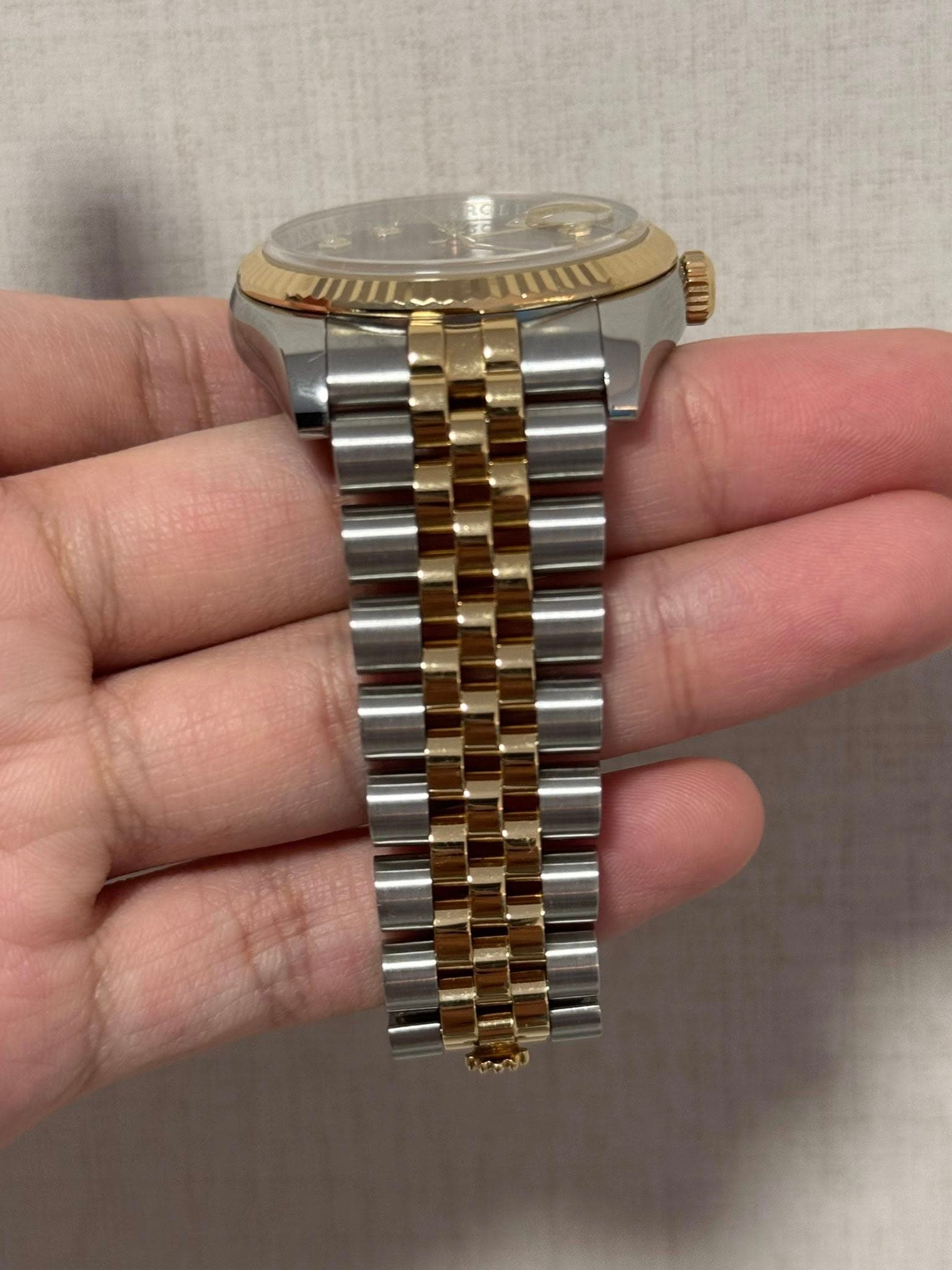 May be an image of wrist watch and text