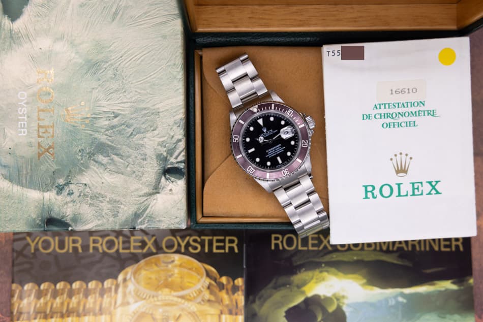 May be an image of wrist watch and text that says 'T55 110 OYSTER ROLEX 50 በር A 16610 ATTESTATION DE CHRONOMETRE OFFICIEL 20 00 0G ന YOUR ROLEX OYSTER ROLEX ROLEX'