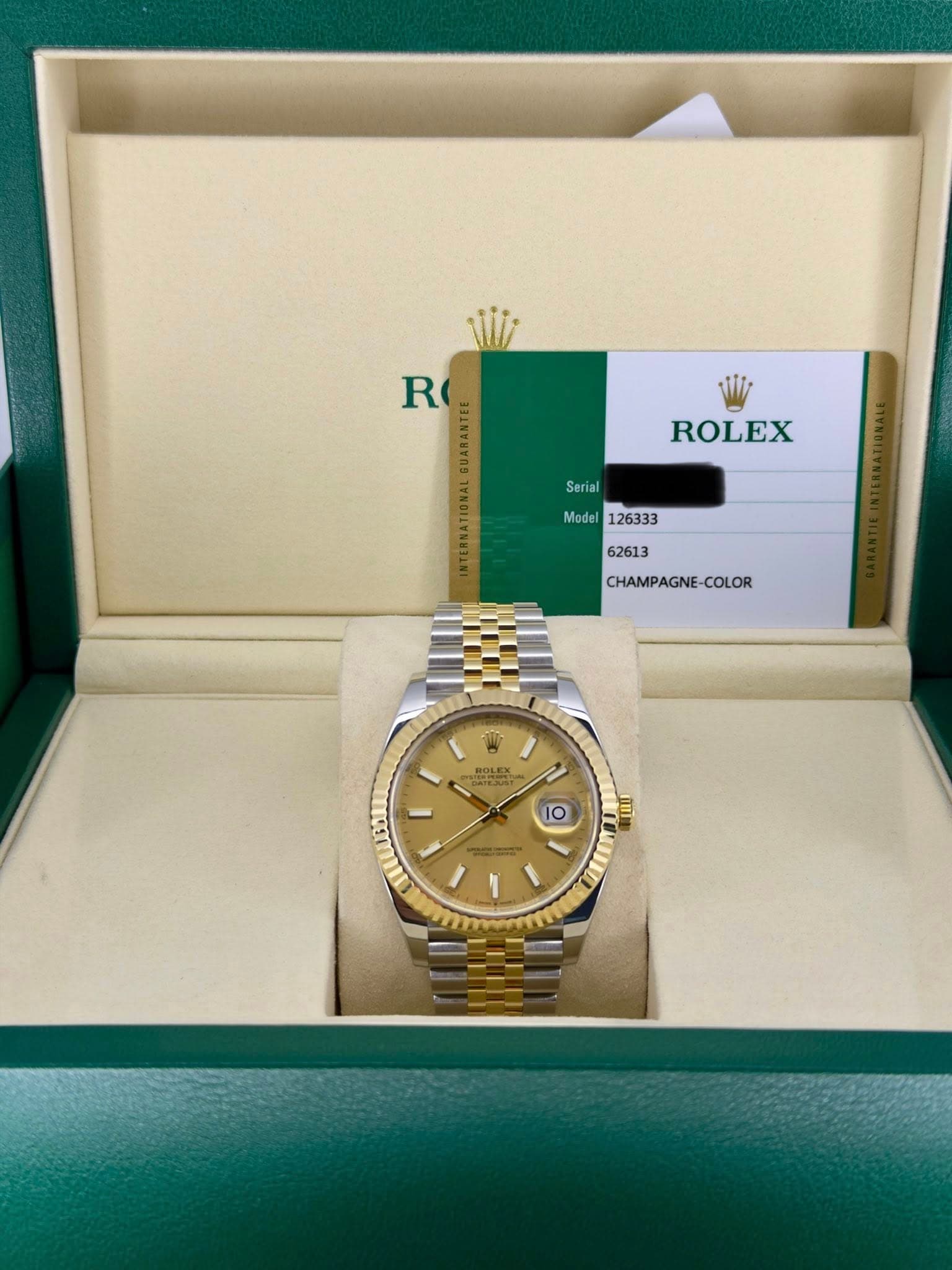 May be an image of wrist watch and text that says 'R 電 ROLEX Serial Model CHAMPAGNE-COLOR COLOR ROLEX 茶 X TESTN 0 റർ'