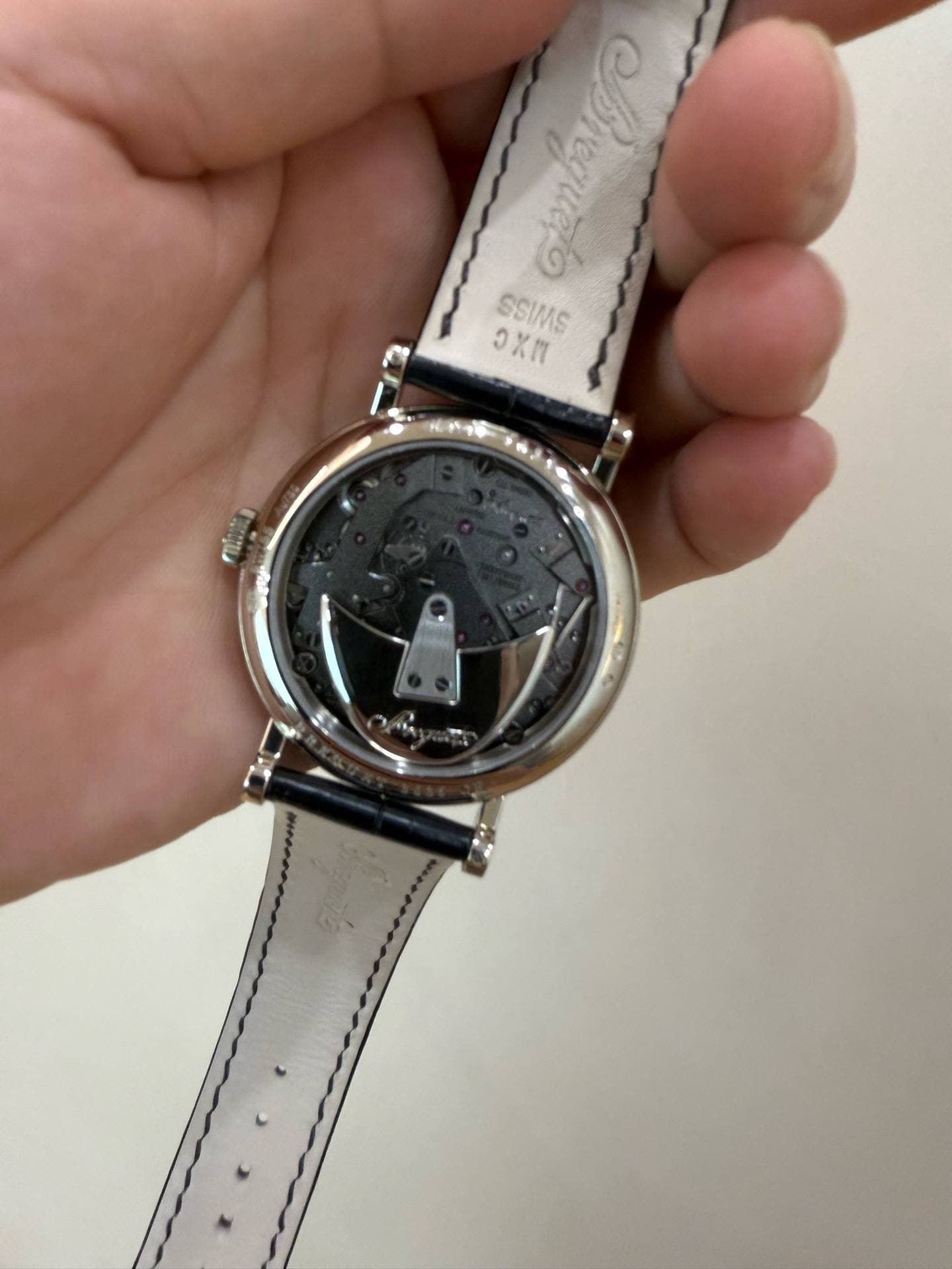 May be an image of wrist watch and text