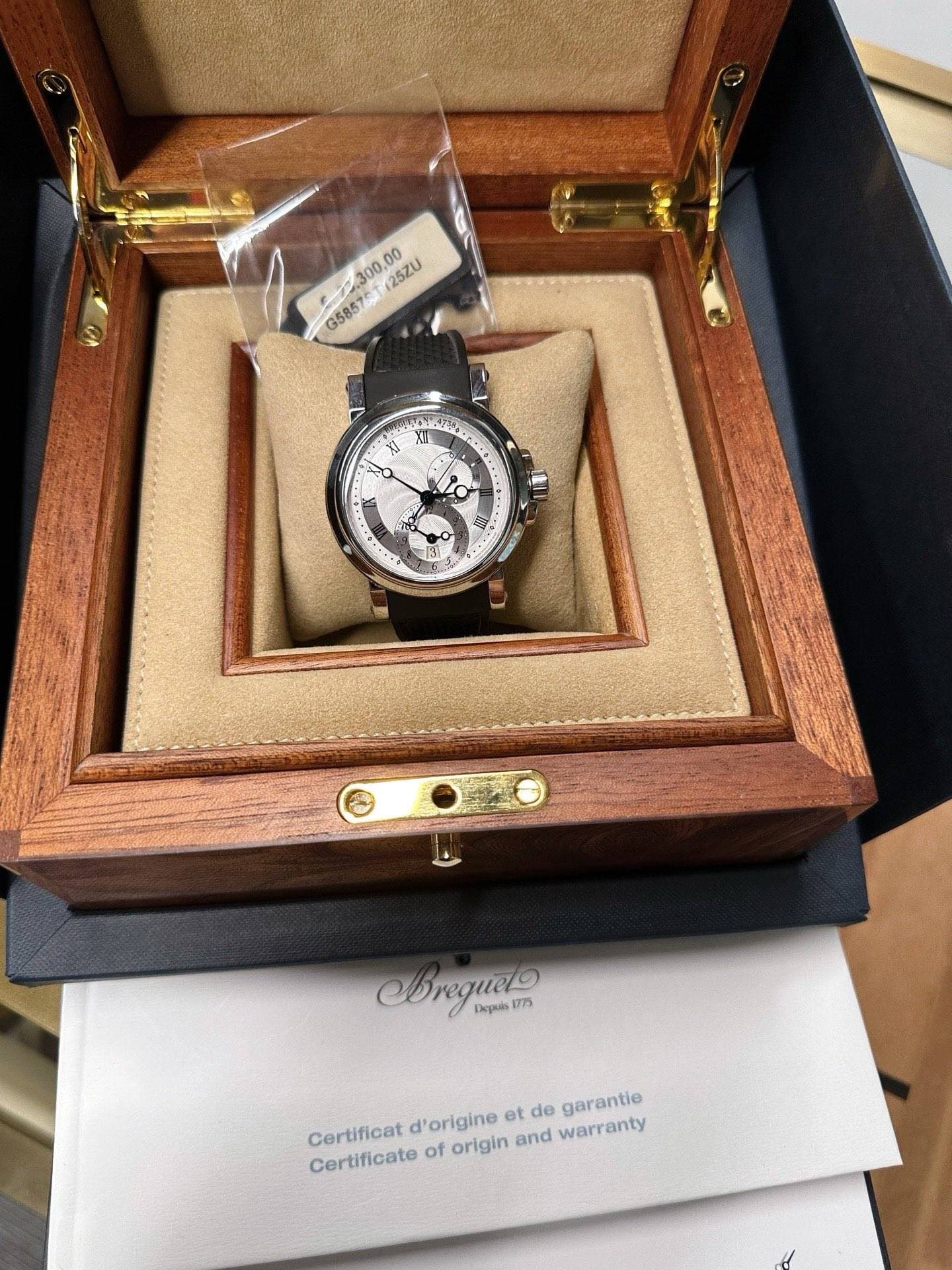 May be an image of wrist watch and text that says '25ZU G5857 .300.00 SA أادی I 1+. 1 ปี Crequelo 1775 Depuls garantie Certificat Certificate of origin and warranty d'origine et…